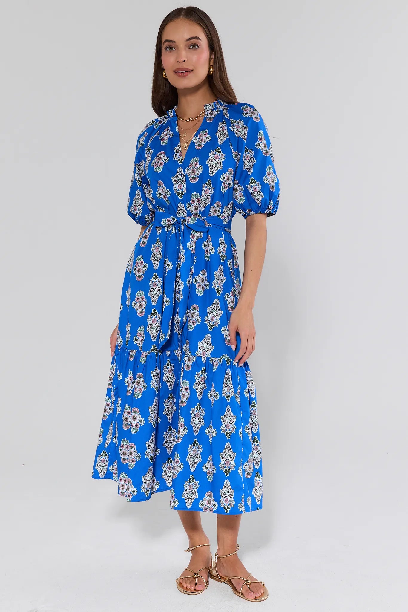 Woman wearing a blue floral dress on a white background