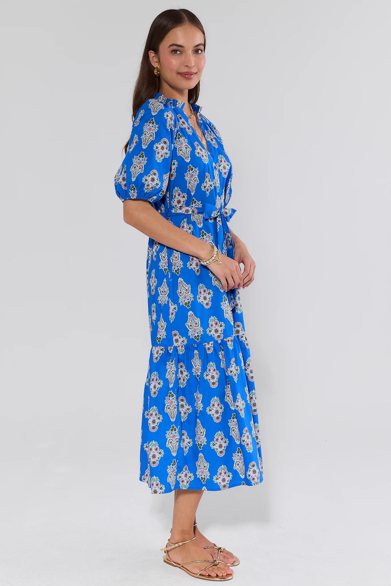 Woman wearing a blue floral dress on a white background