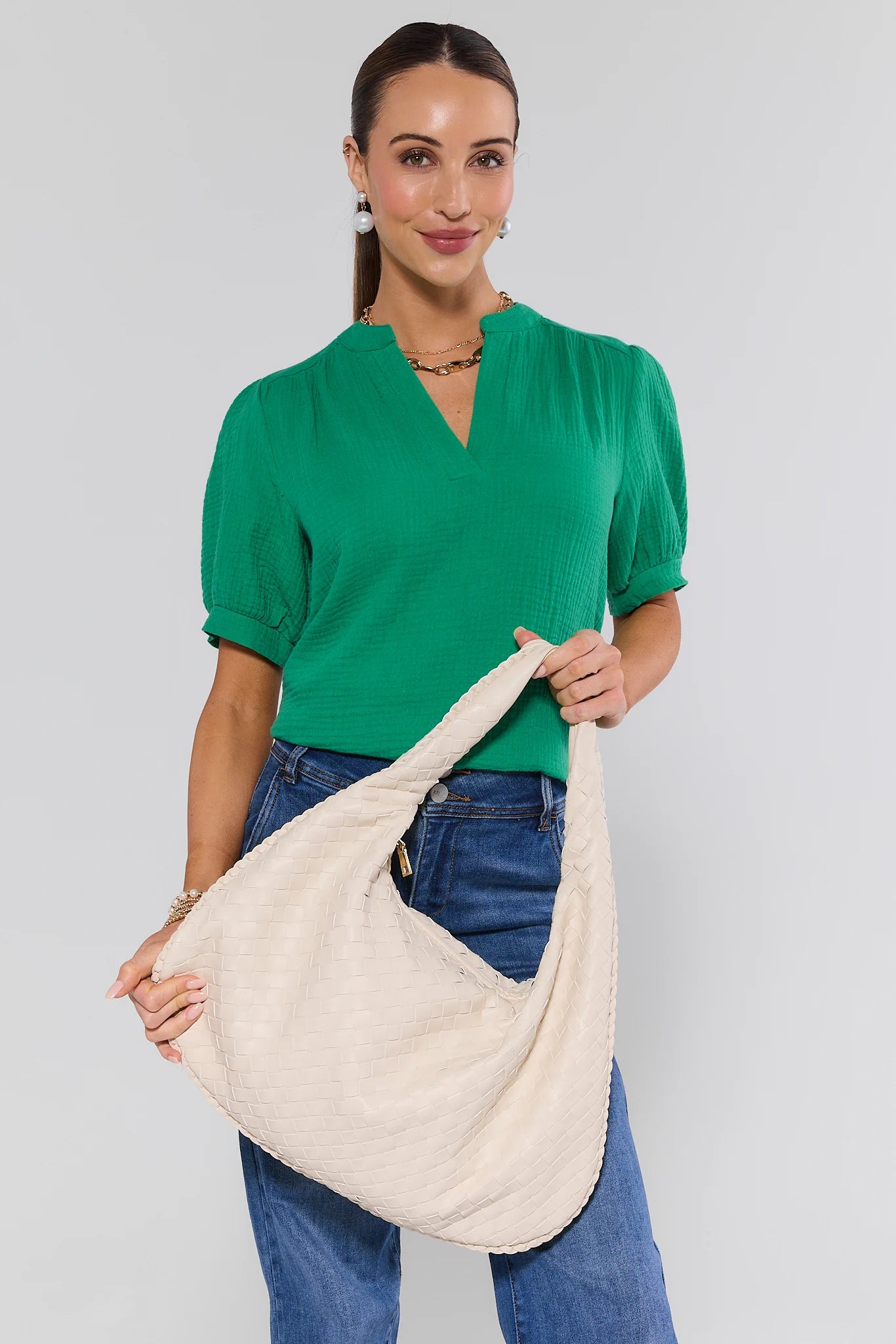 woman holding Brianna Ivory Woven Bag