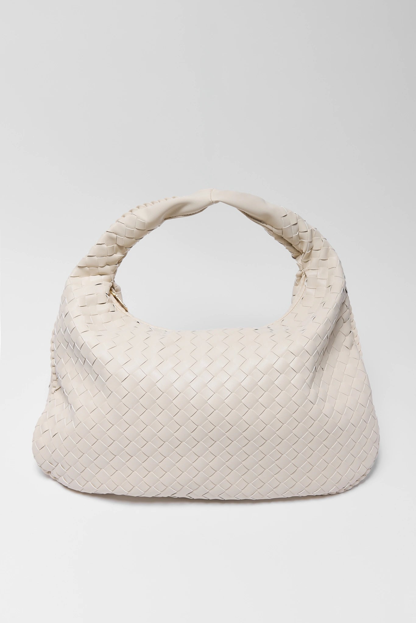 White woven handbag on a light gray background