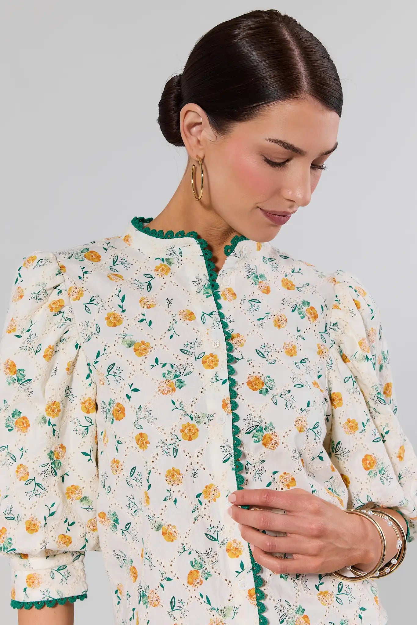 Woman wearing a floral patterned jacket against a plain background