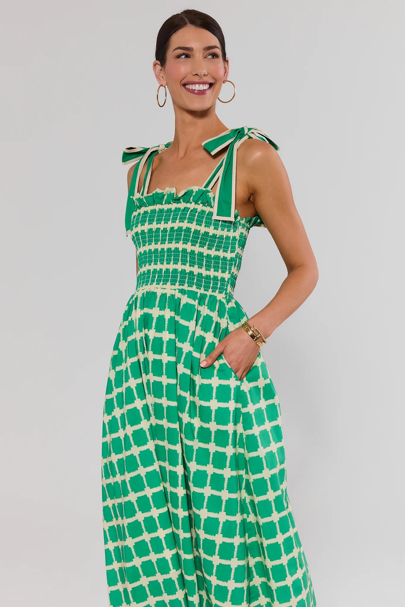 woman wearing green talia dress on white background
