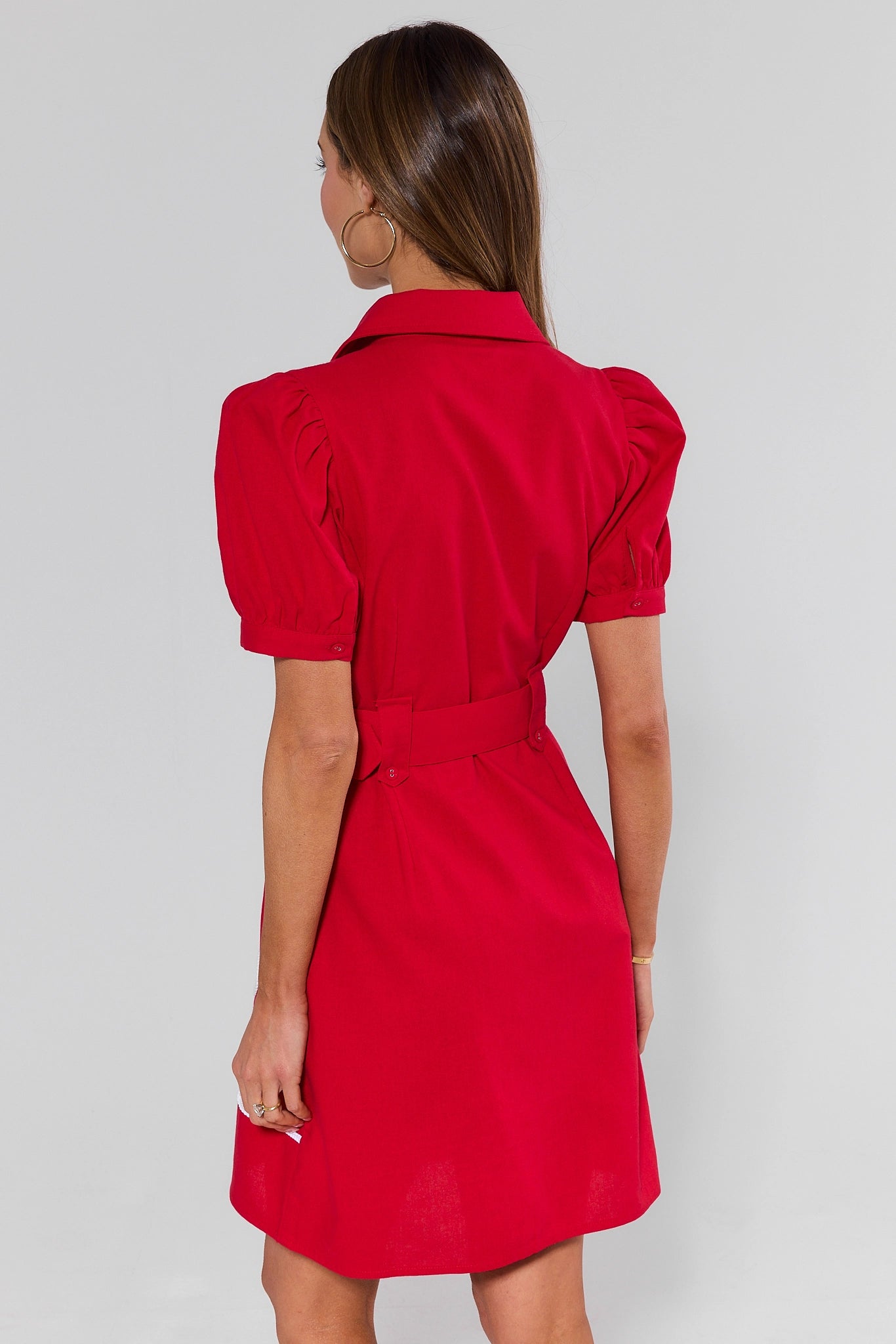 standing Red dress with puff sleeves worn by a person on a plain background