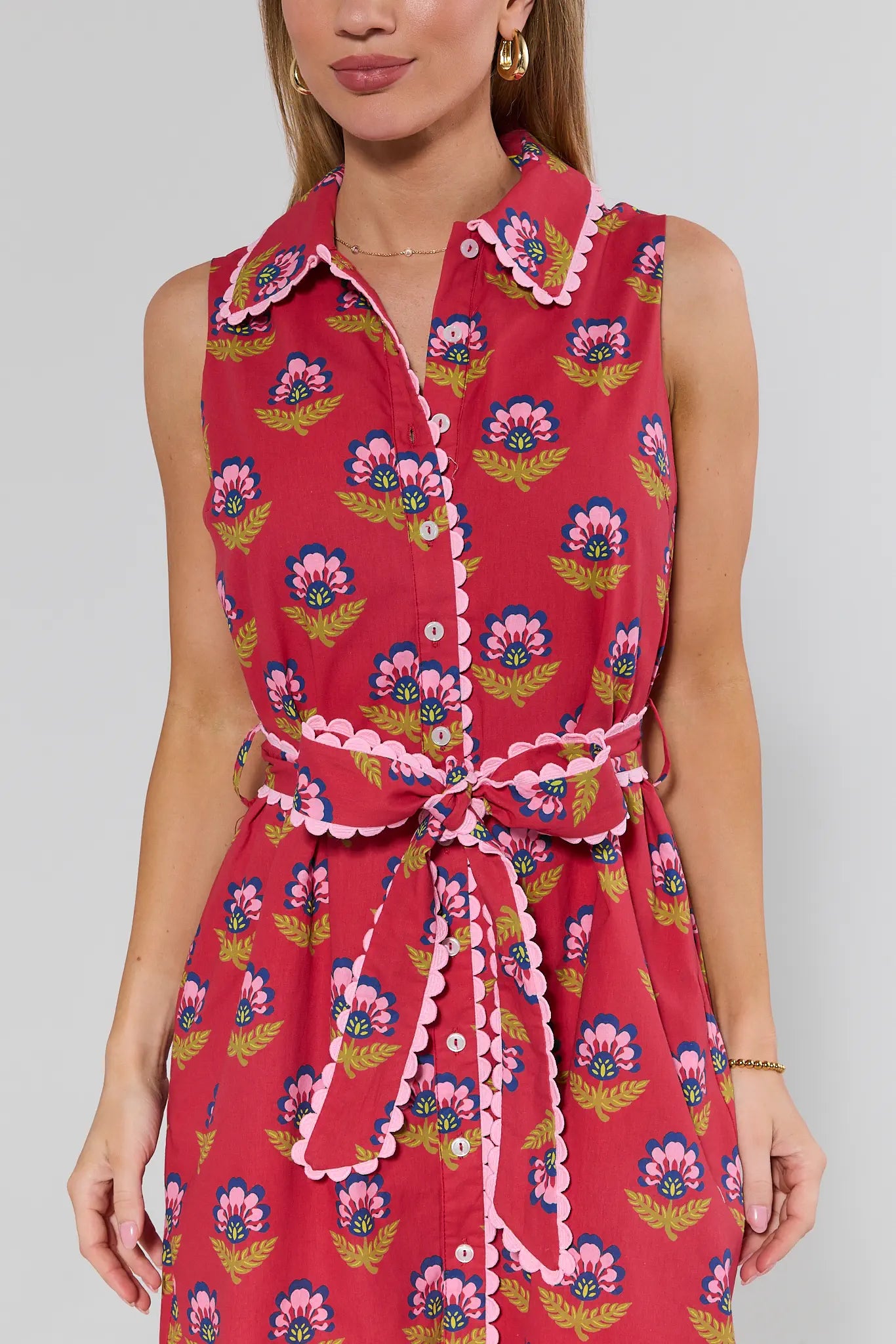 Woman wearing a red floral dress with a white background