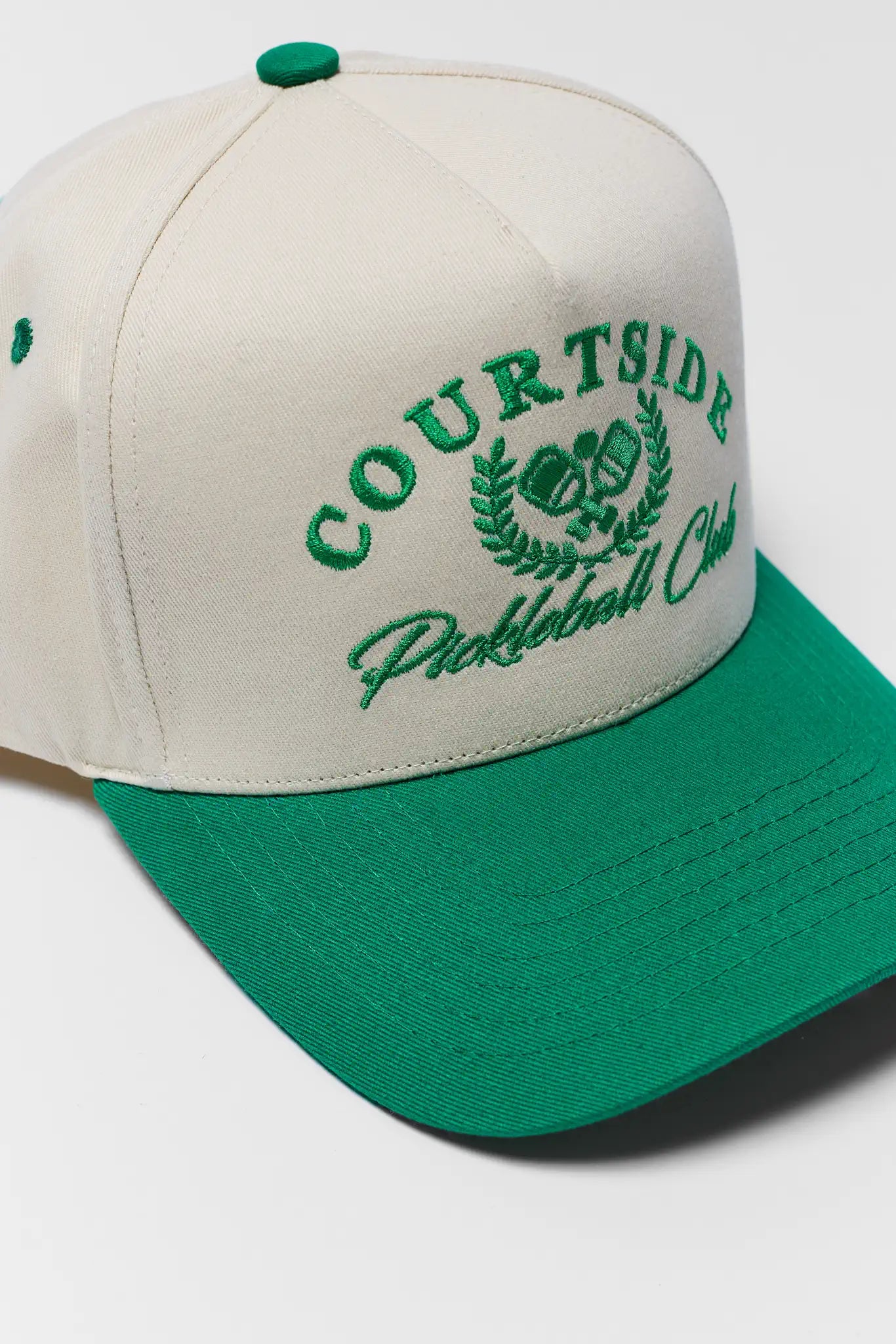 Beige and green cap with 'Courtside Pickleball Club' embroidery on a white background