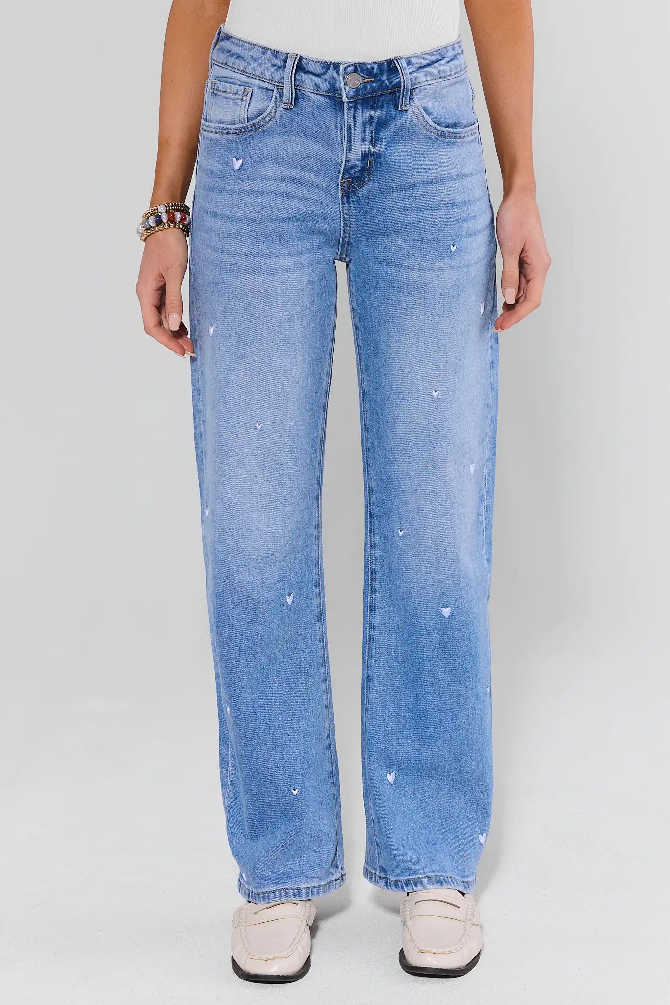 Light blue jeans worn by a person on a white background