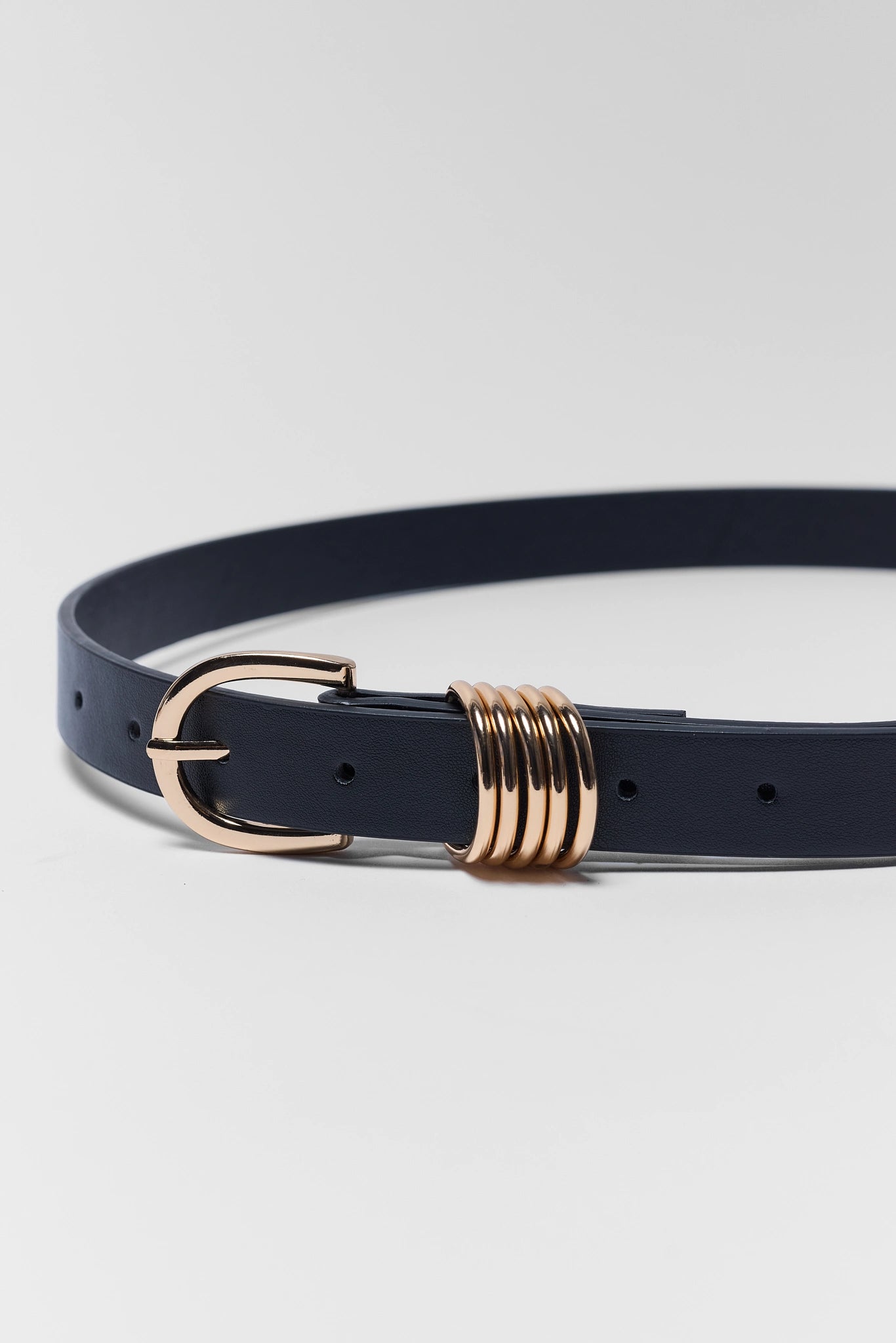 Navy belt with a gold buckle on a light gray background