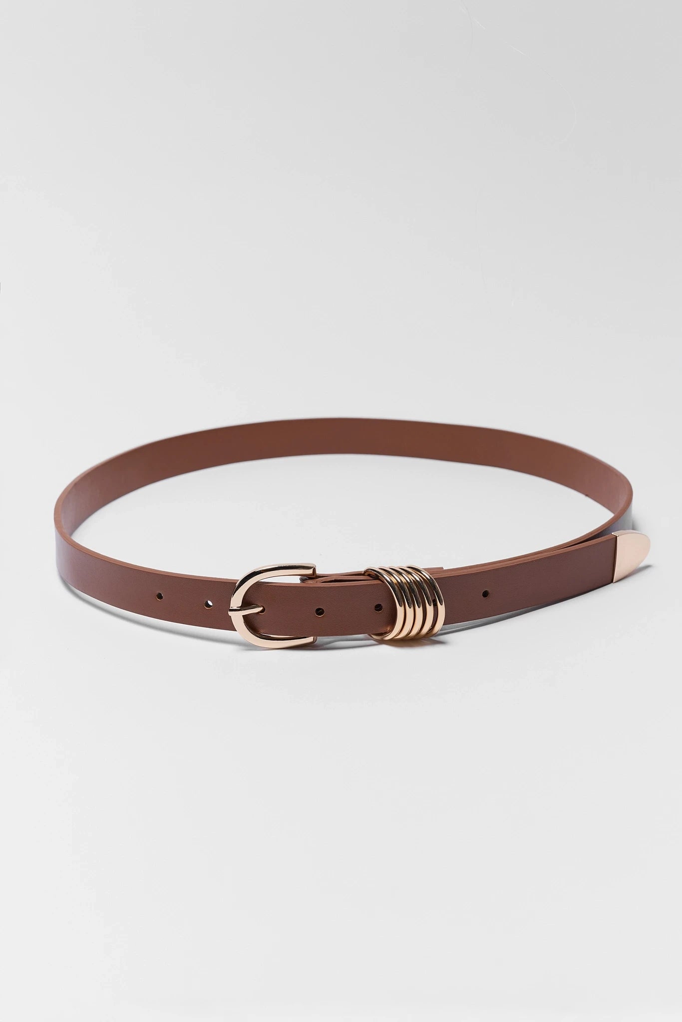 Brown belt with a gold buckle on a light gray background