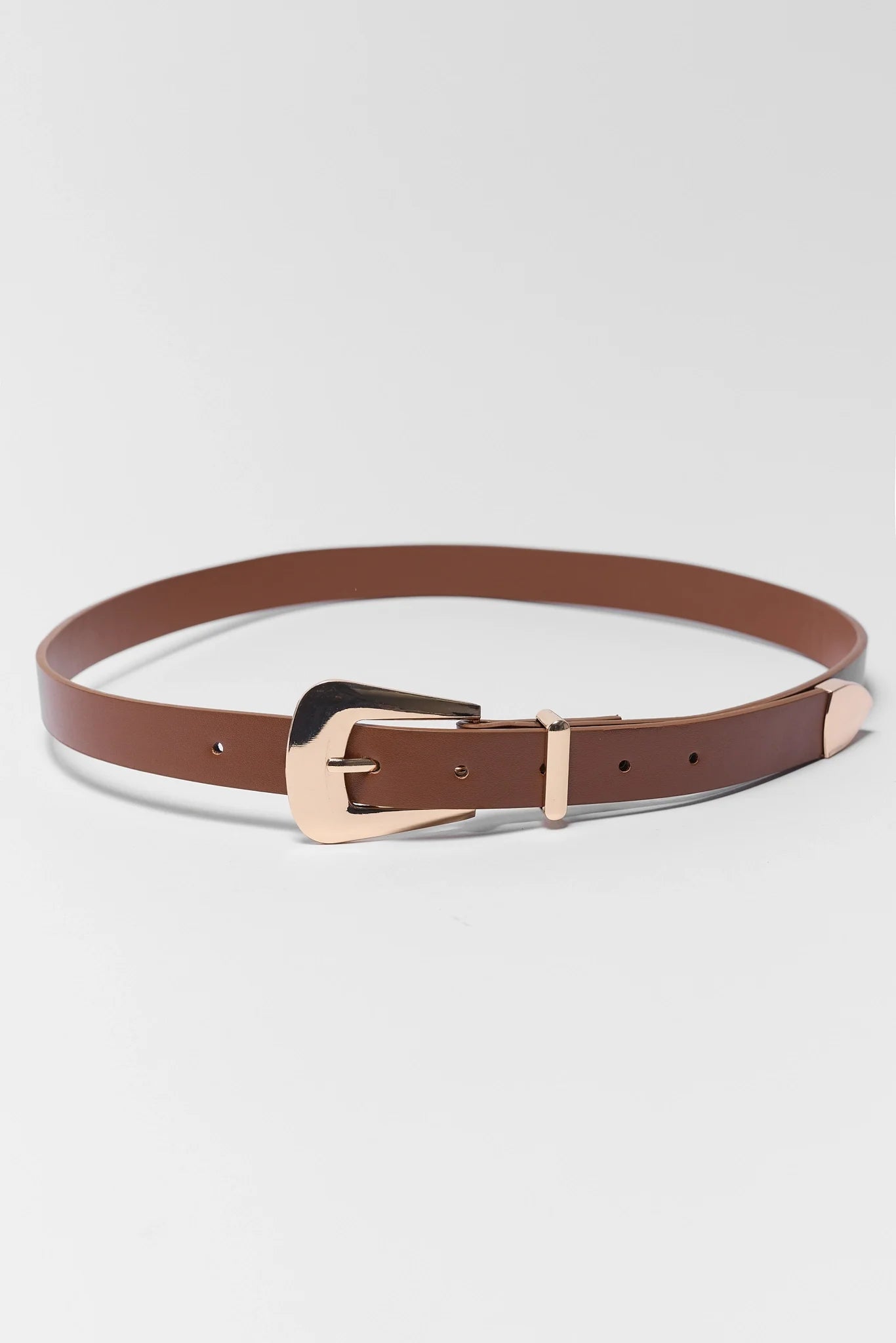 Brown belt with a rose gold buckle on a light gray background