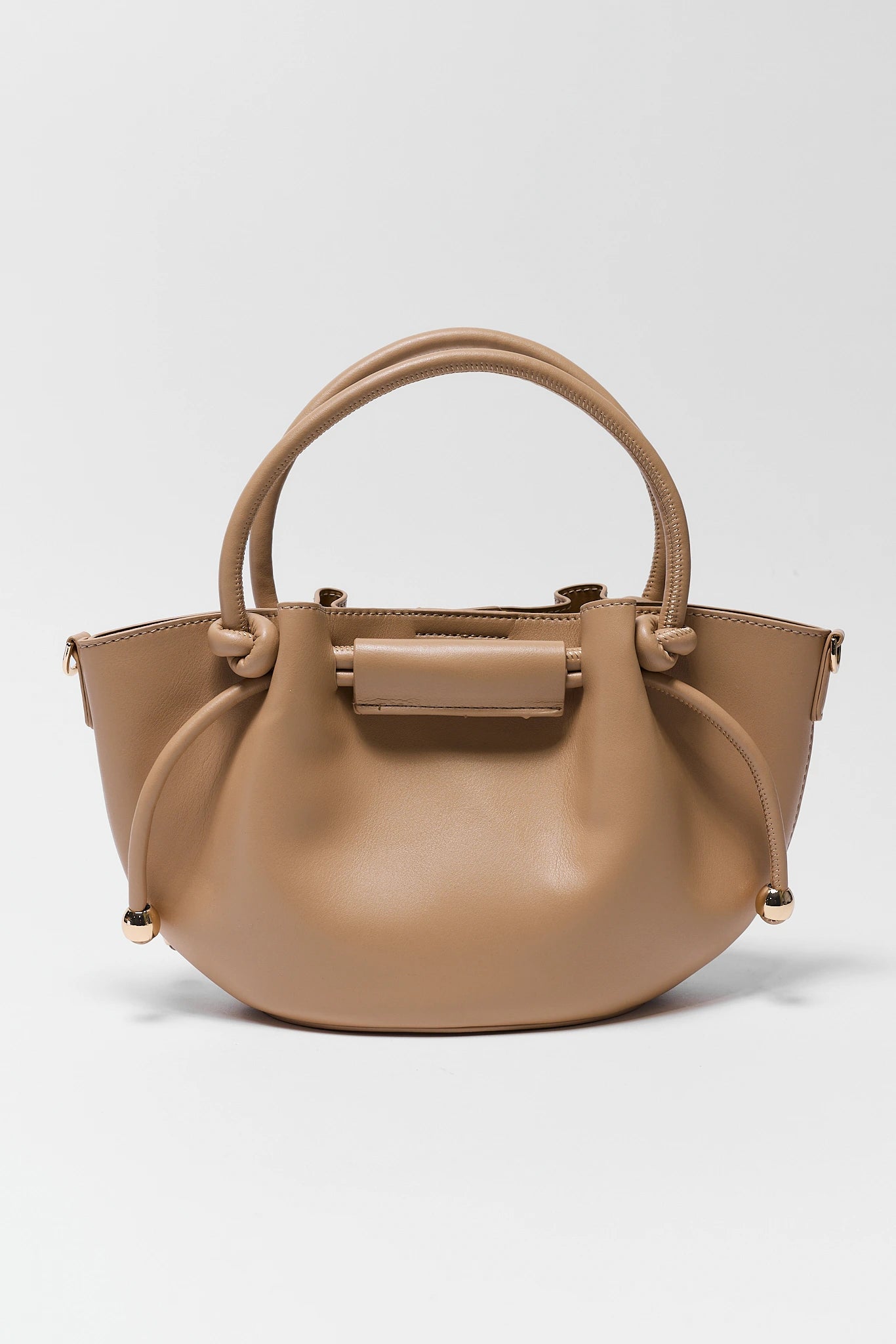 Beige handbag with a handle on a light gray background