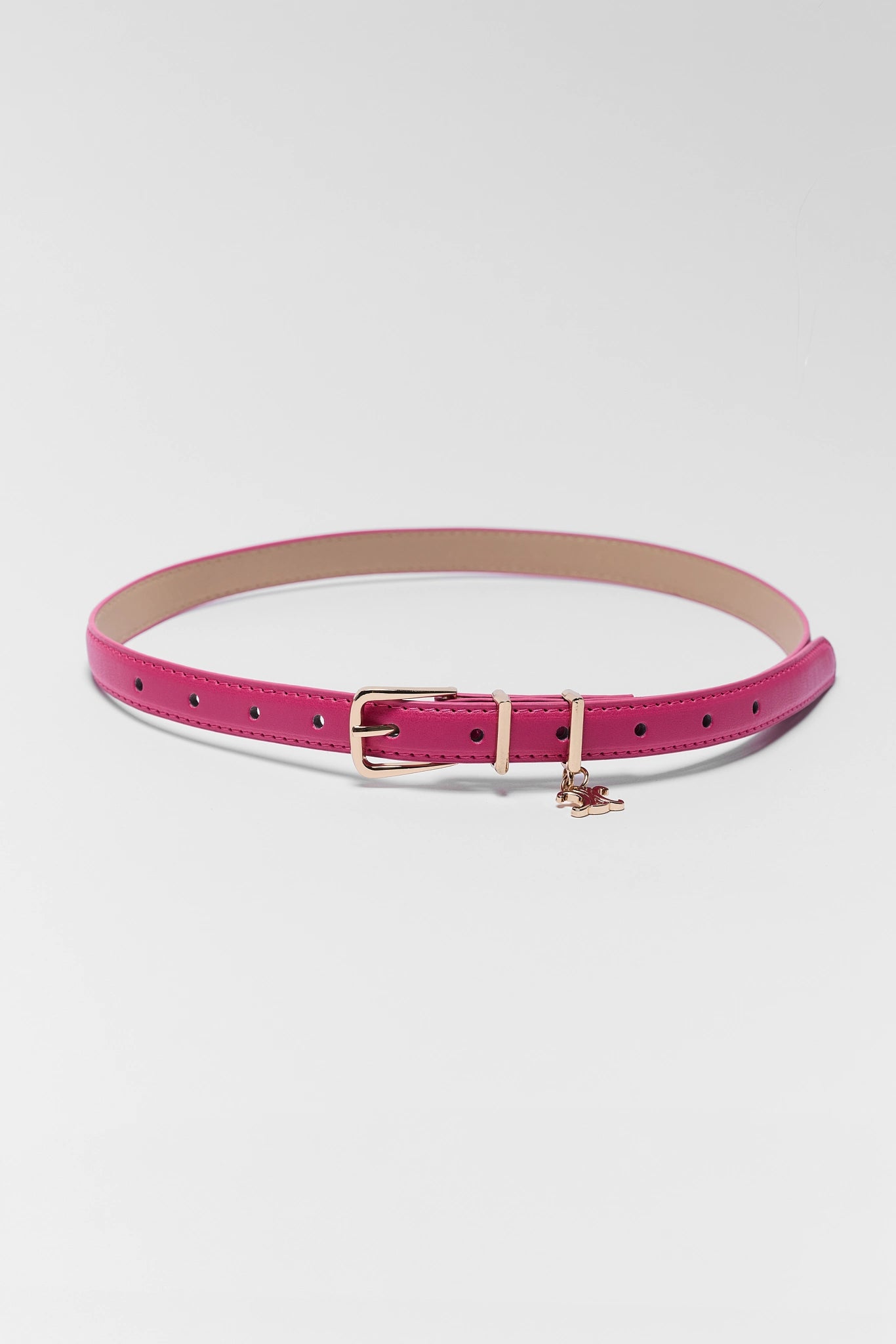 Pink belt with a gold buckle on a white background