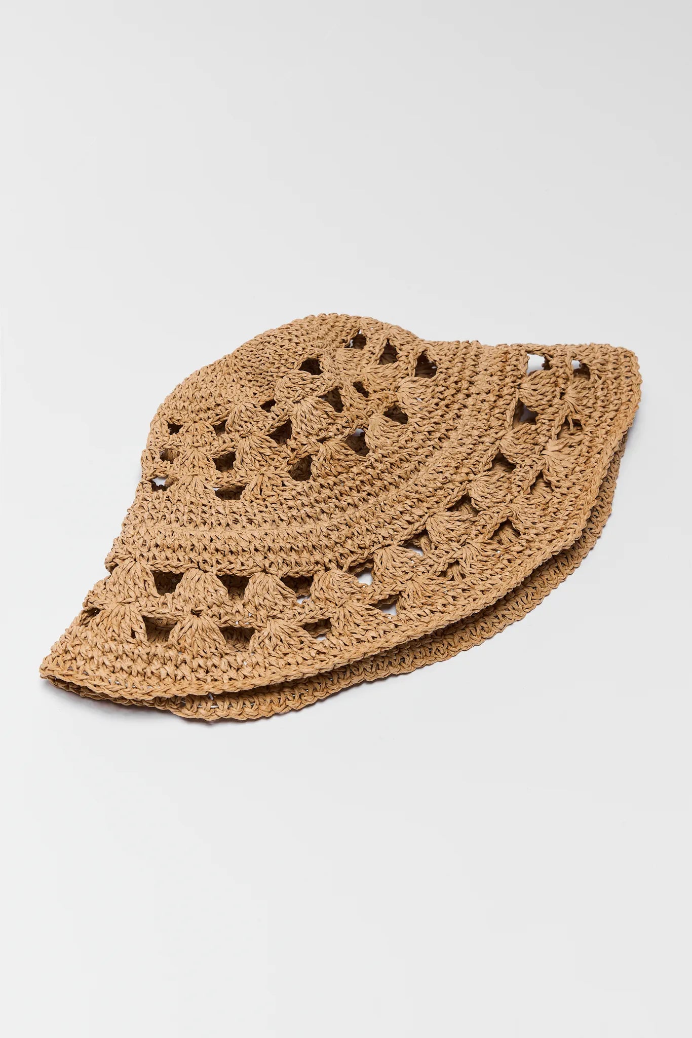 Brown crochet hat on a light gray background