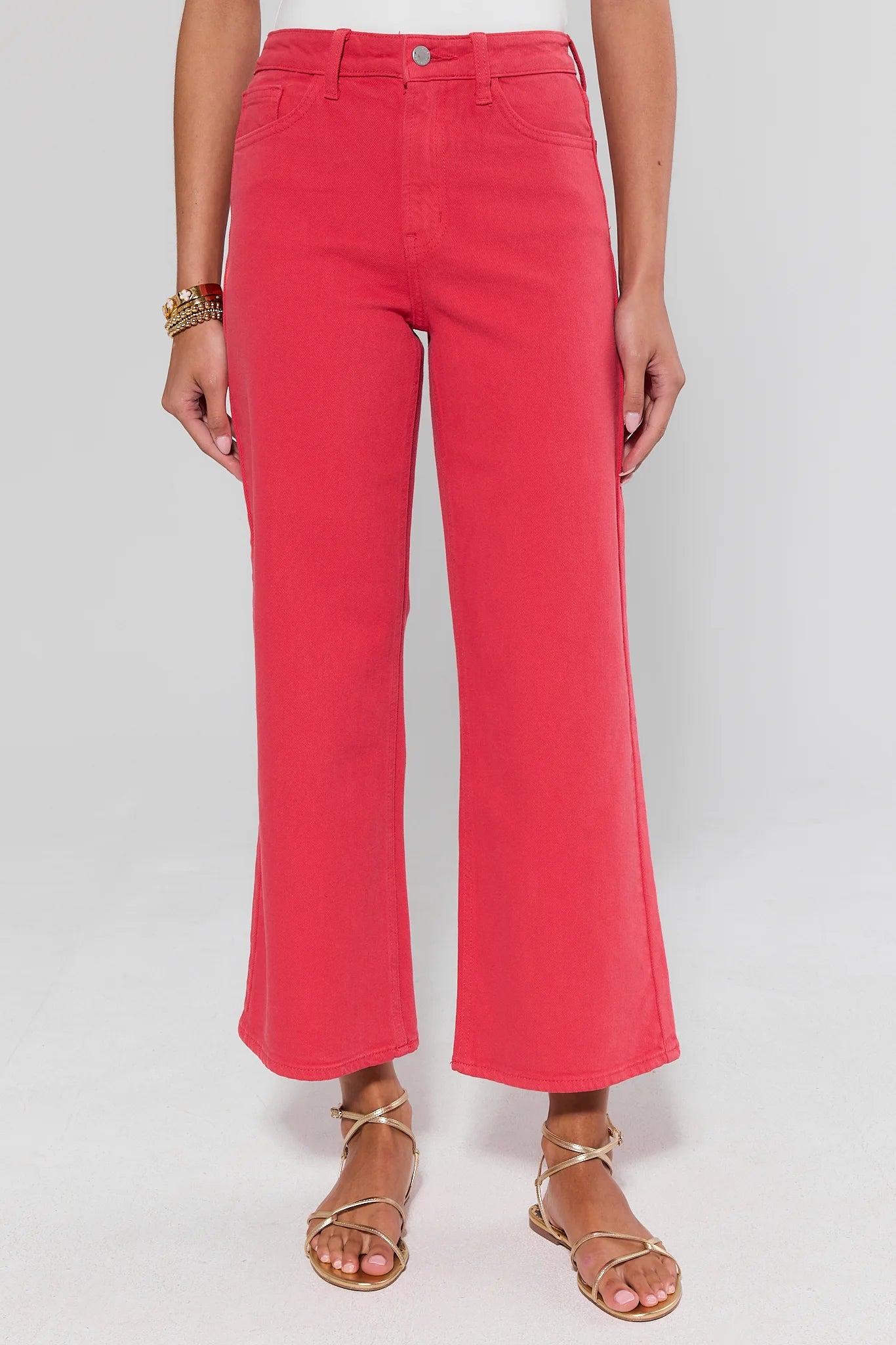 Person wearing bright pink pants on a white background