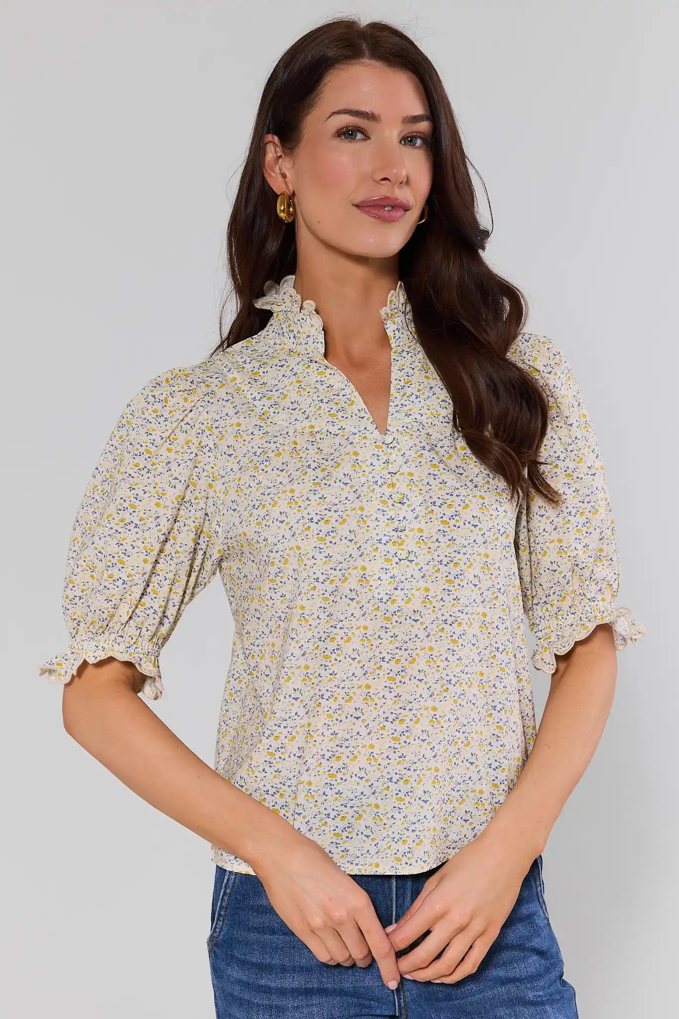 Woman wearing a hailey floral blouse with a plain background