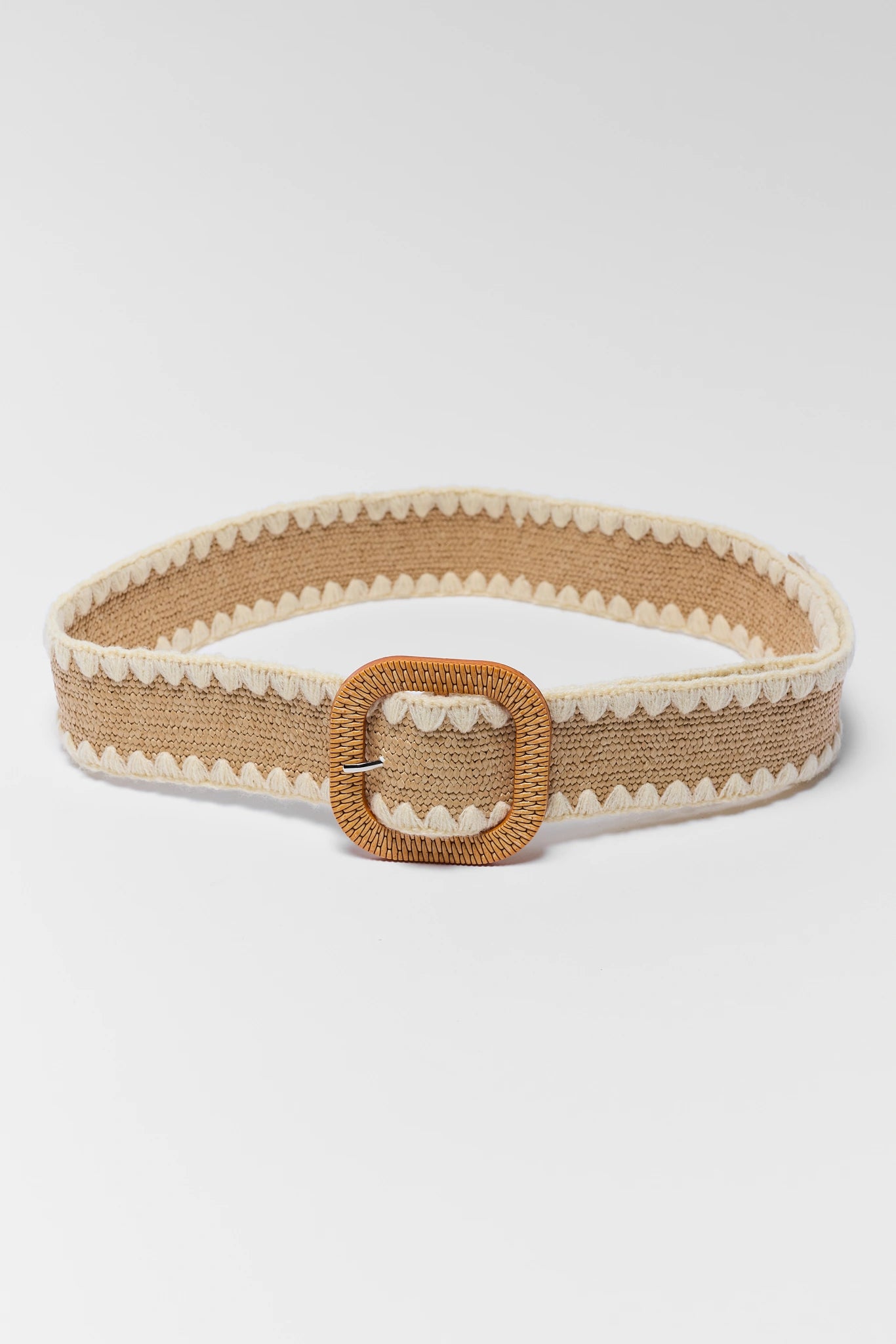 Beige belt with a decorative buckle on a white background