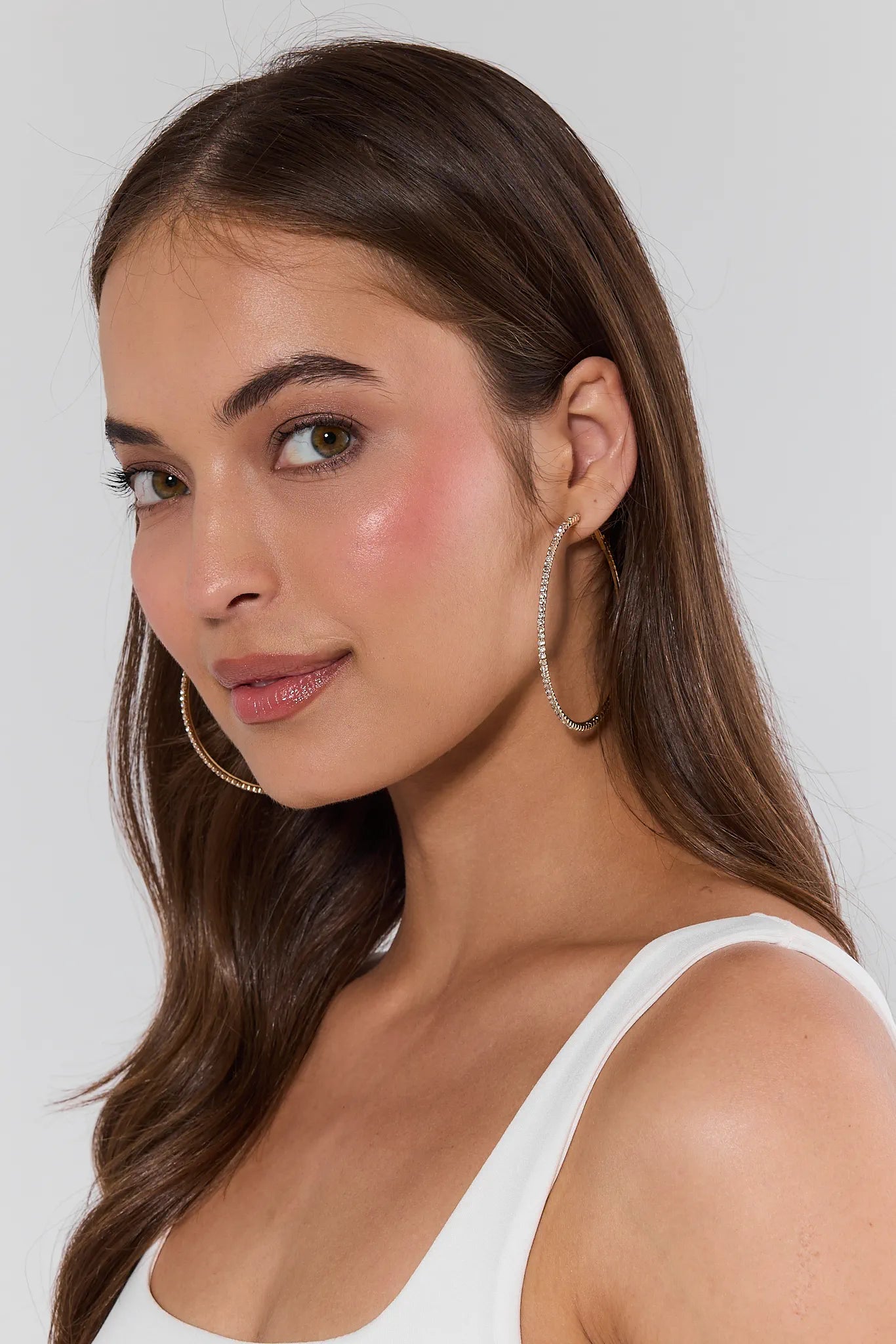 woman wearing gold rhinestone hoop earrings