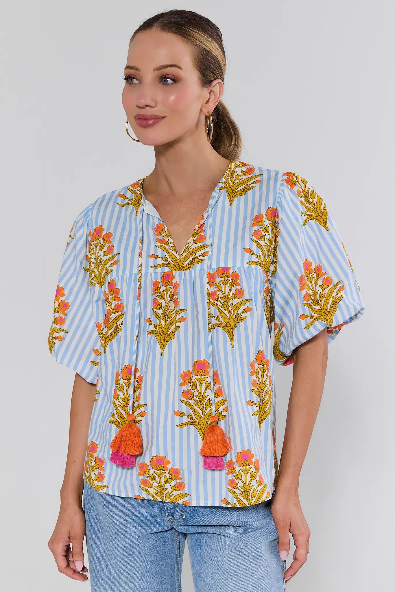 Woman wearing a floral blouse with a white background