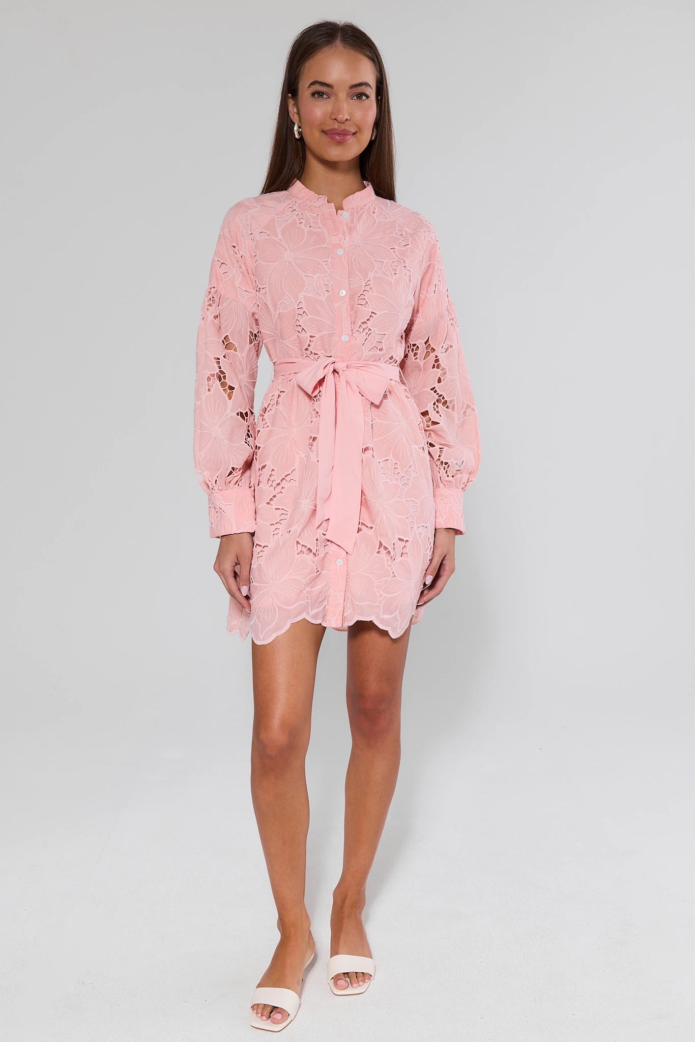 Woman wearing a pink floral dress on a white background