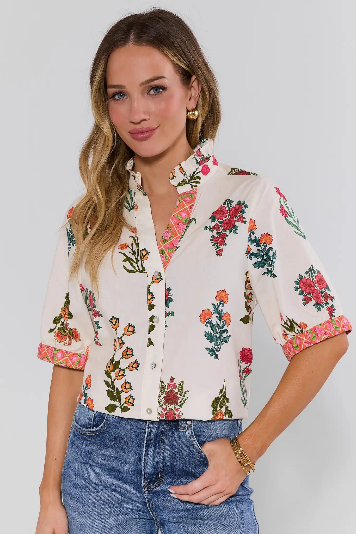 Woman wearing a floral blouse with a plain background