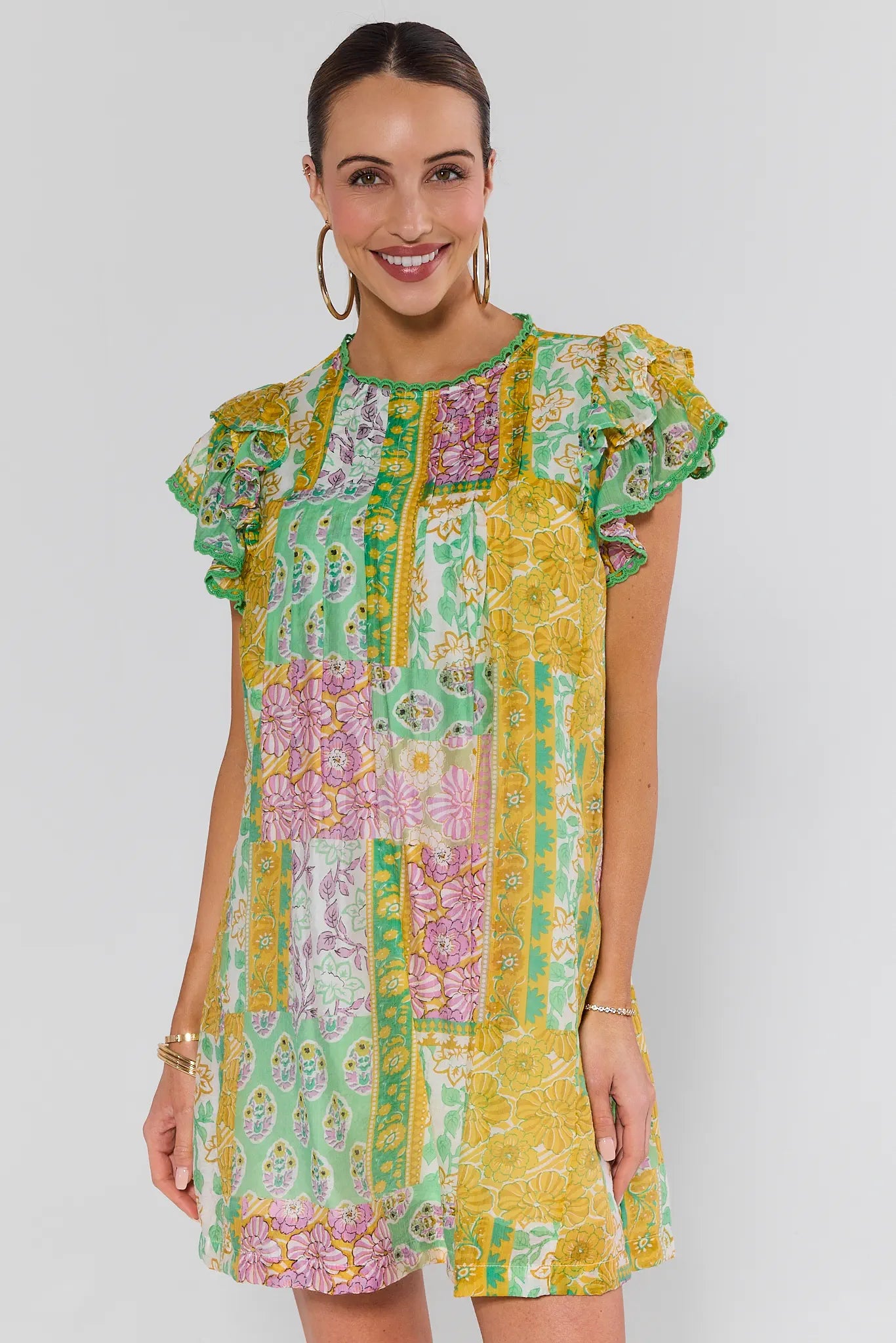 Woman wearing a colorful patterned dress on a white background