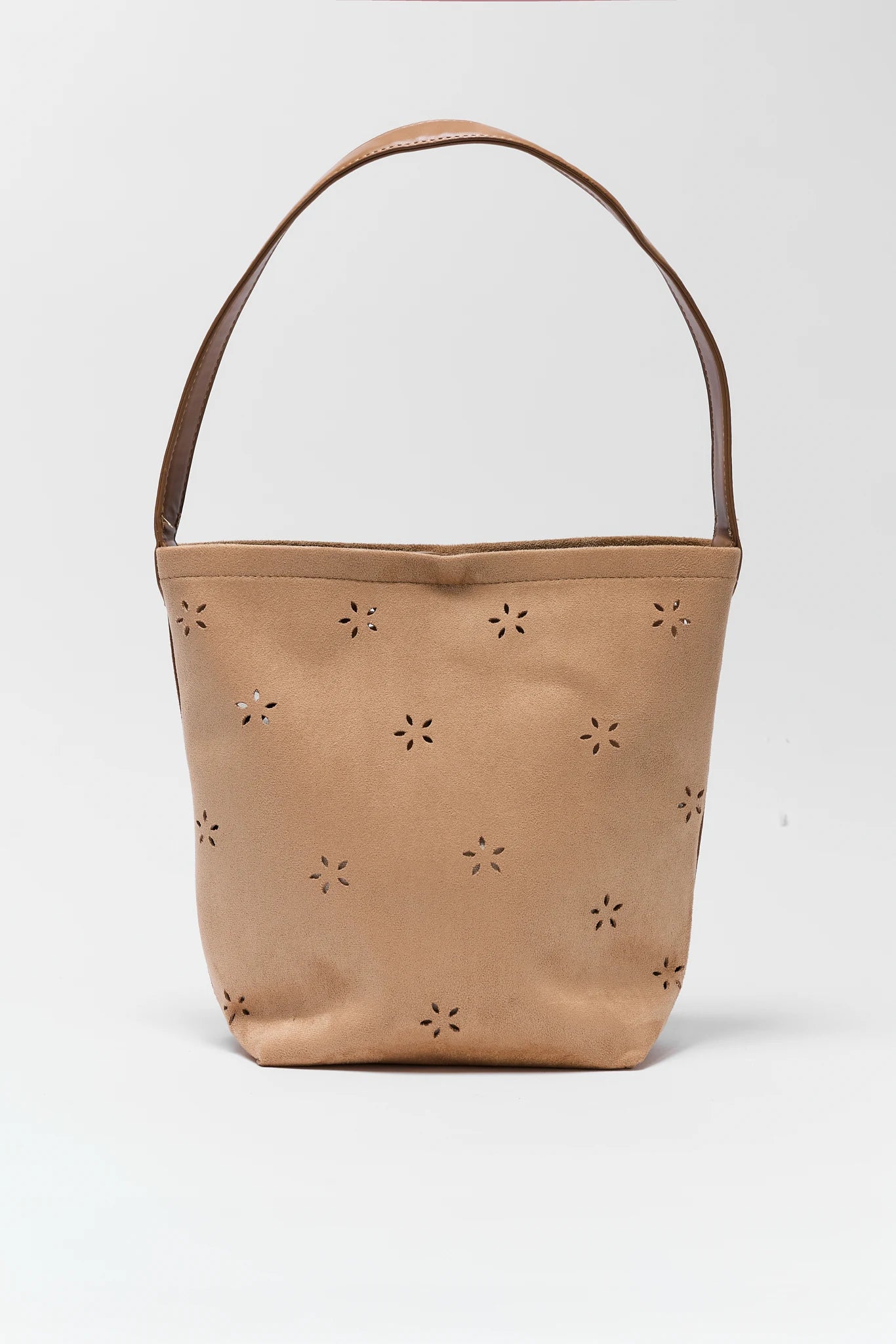 Tan bucket bag with star-shaped cutouts on a white background