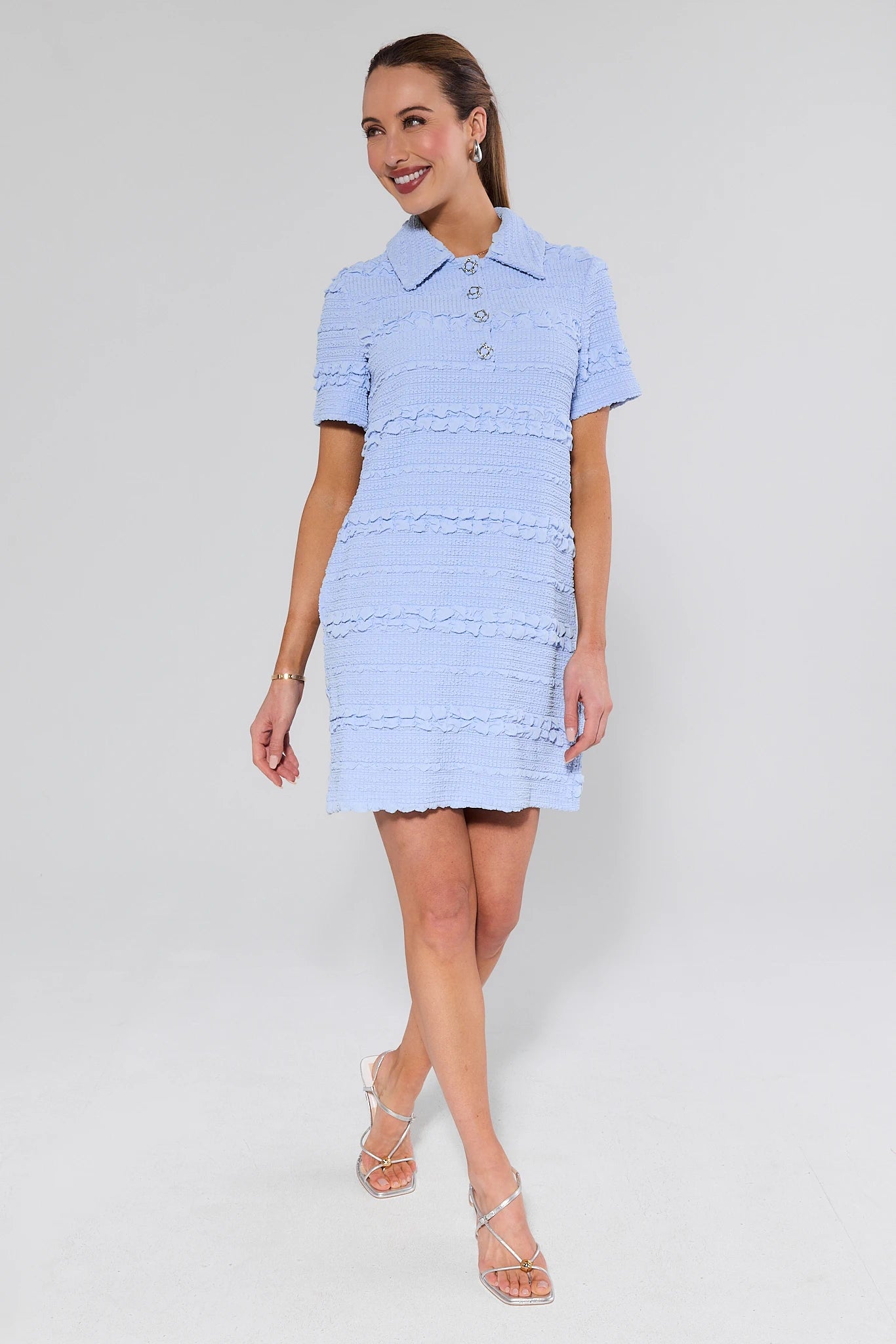 Woman wearing a light blue dress with a white background