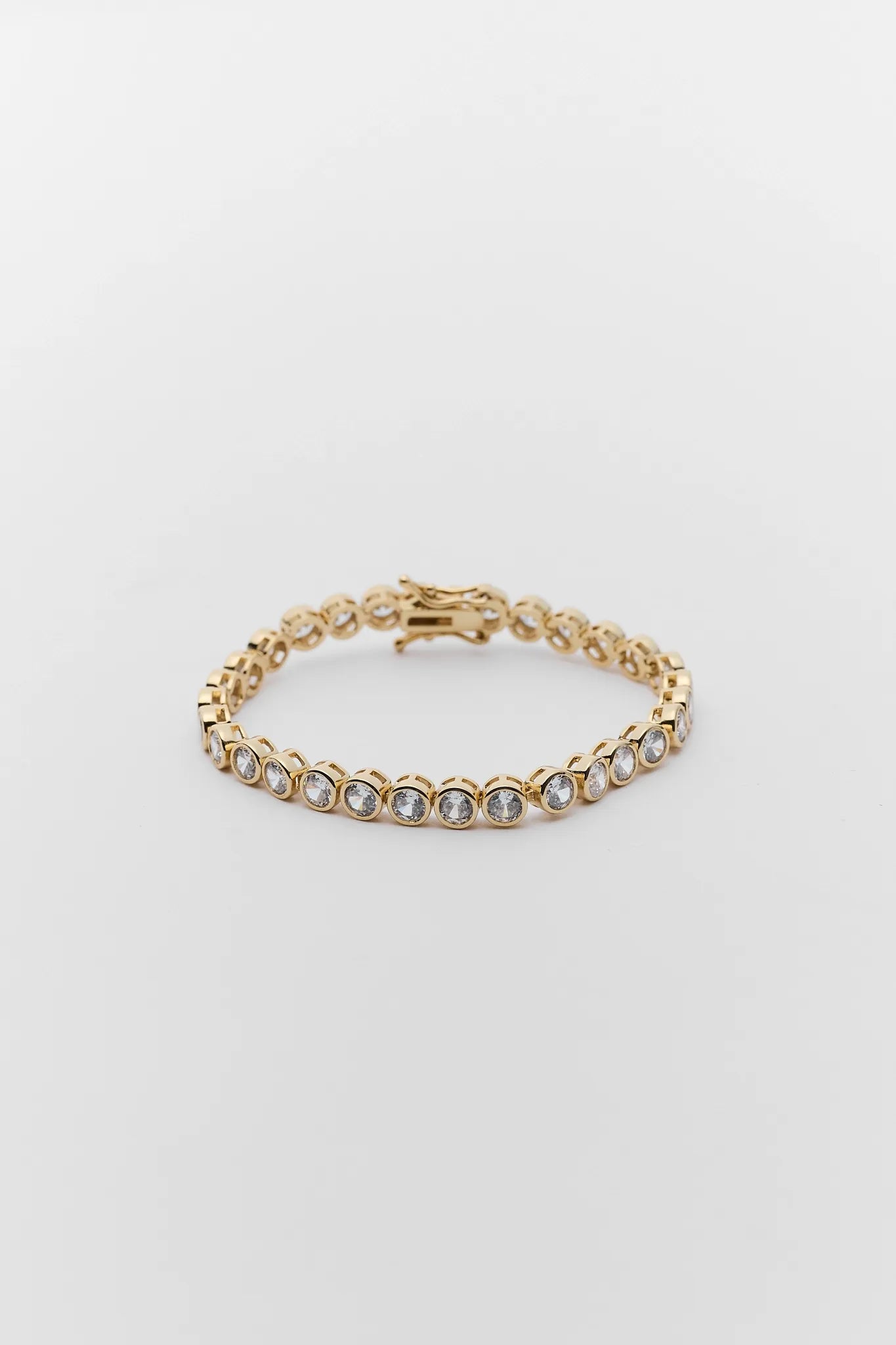 Gold Round Bezel Tennis Bracelet on white background