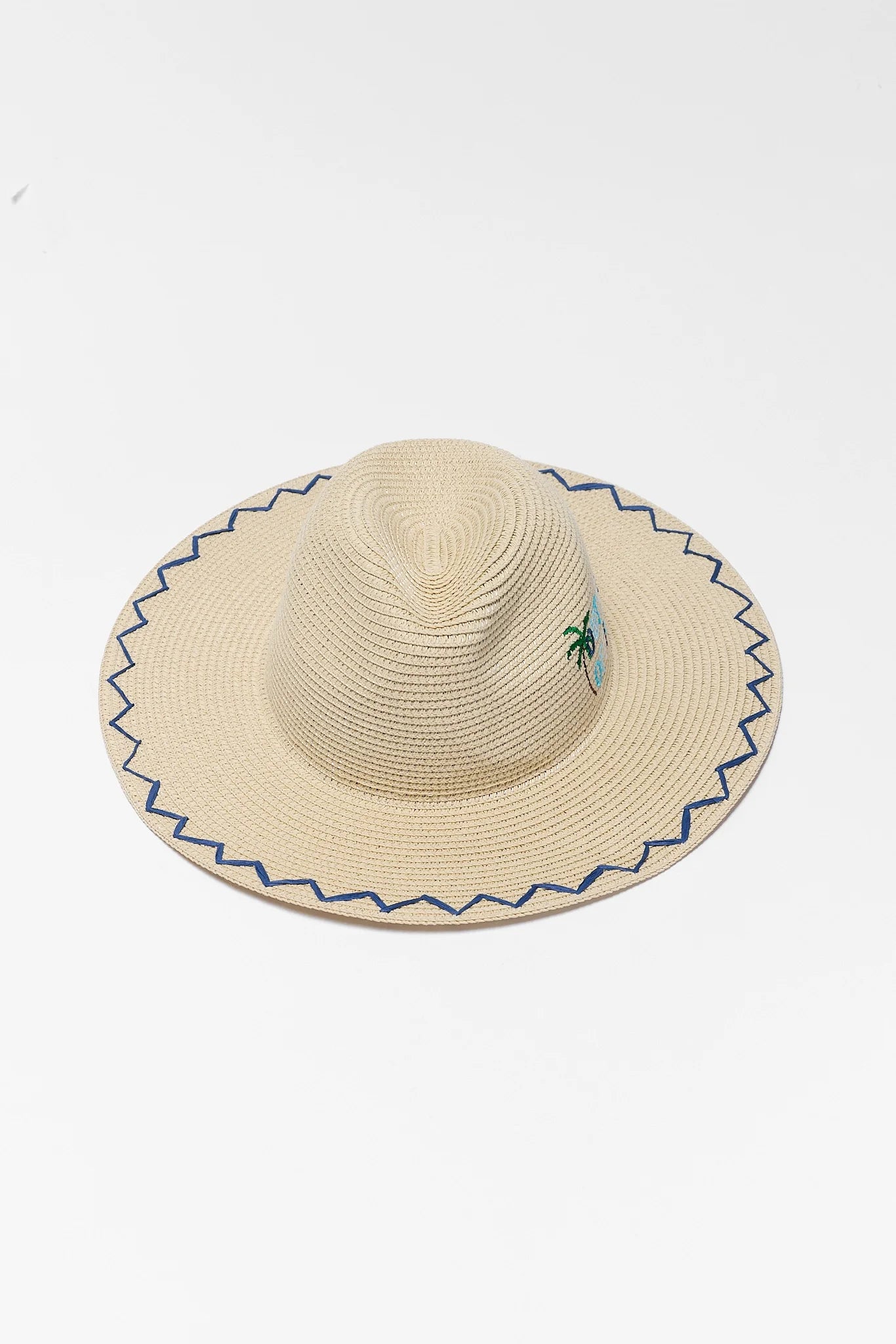 Beige straw hat with blue trim on a white background