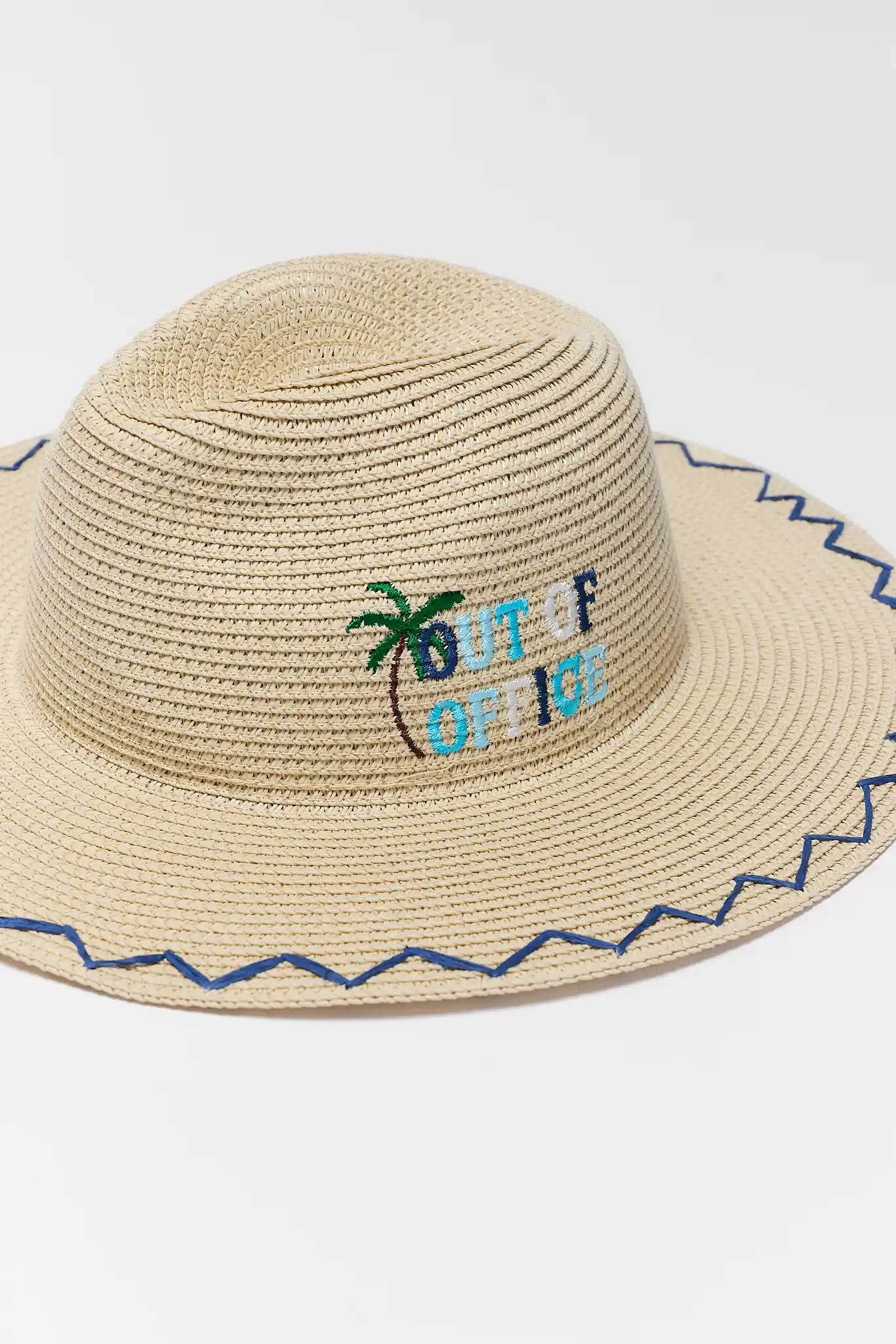 Beige straw hat with 'Out of Office' text and palm tree design on a white background