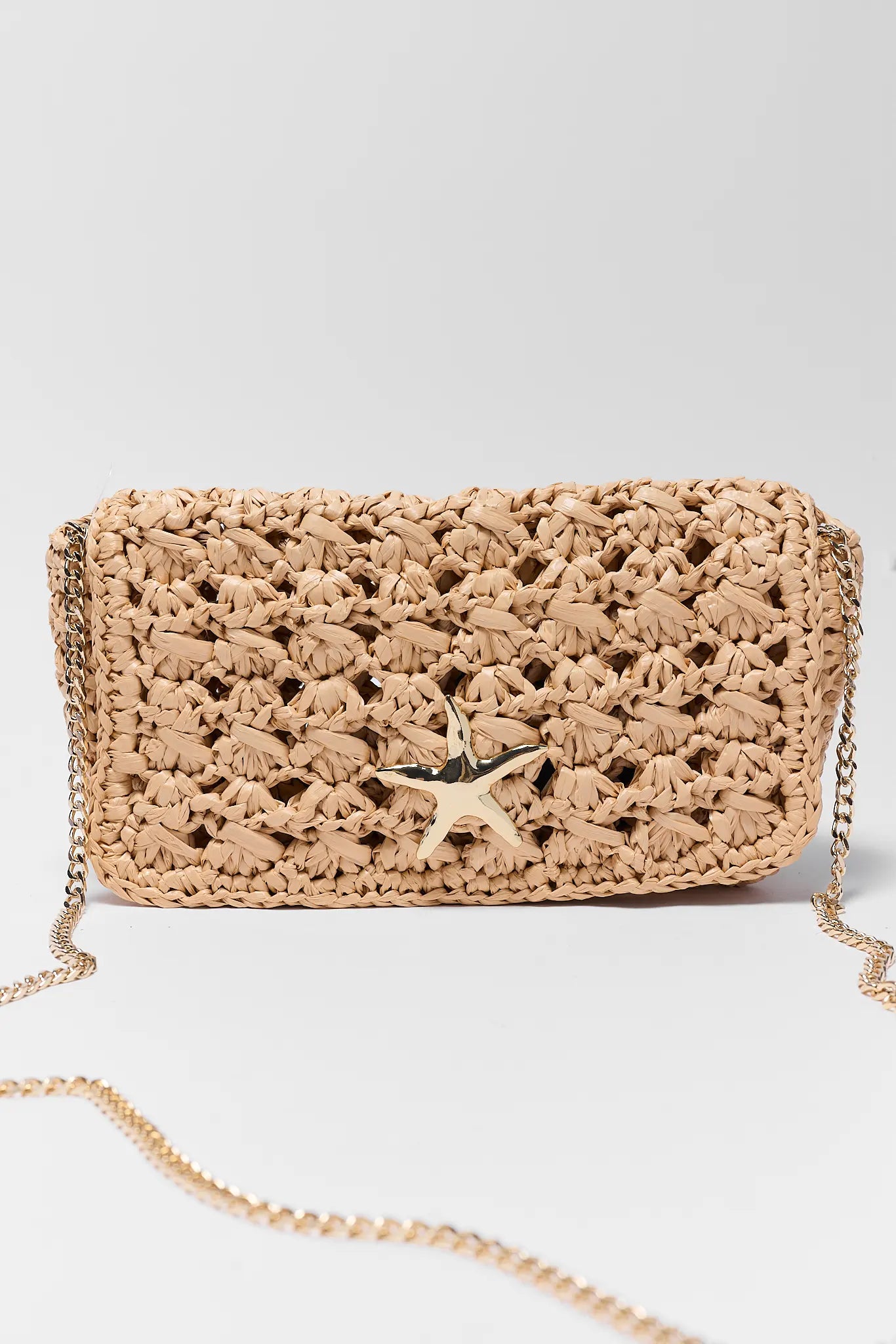 Woven handbag with star detail on a light gray background