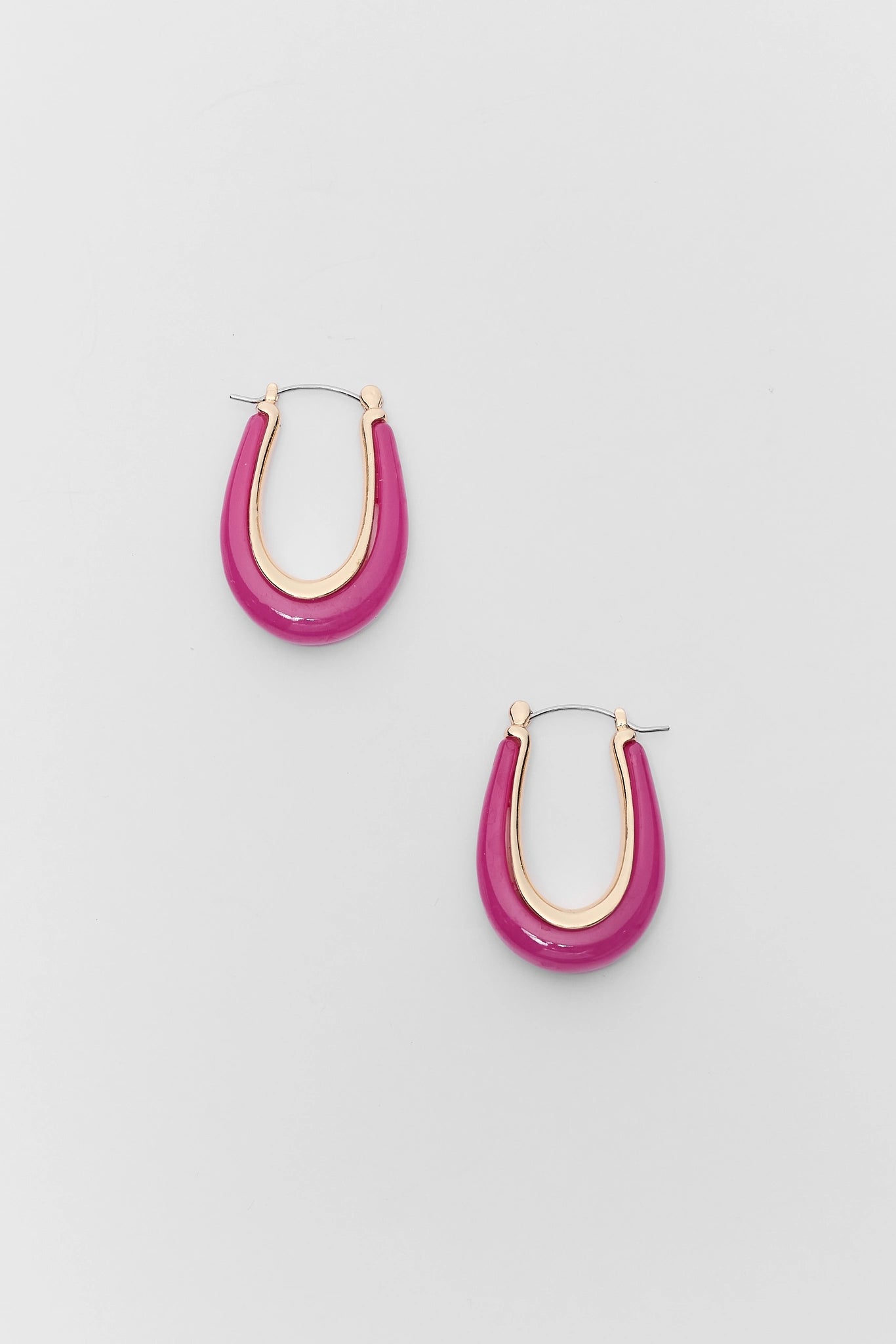 Pair of pink hoop earrings on a light gray background
