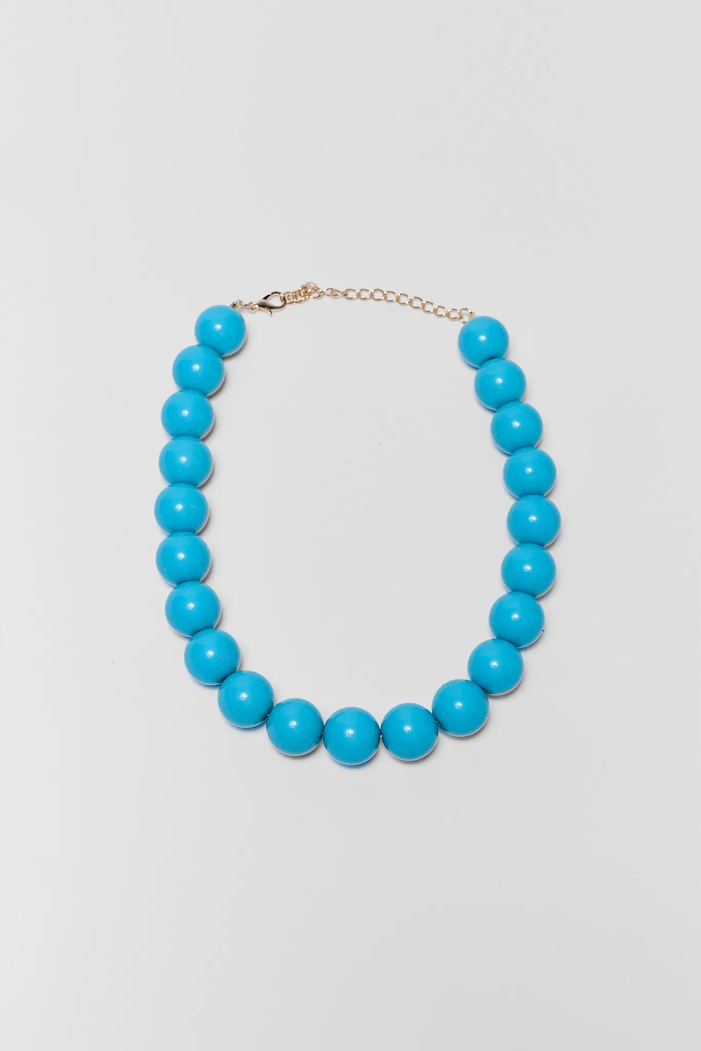 Turquoise beaded necklace on a light gray background