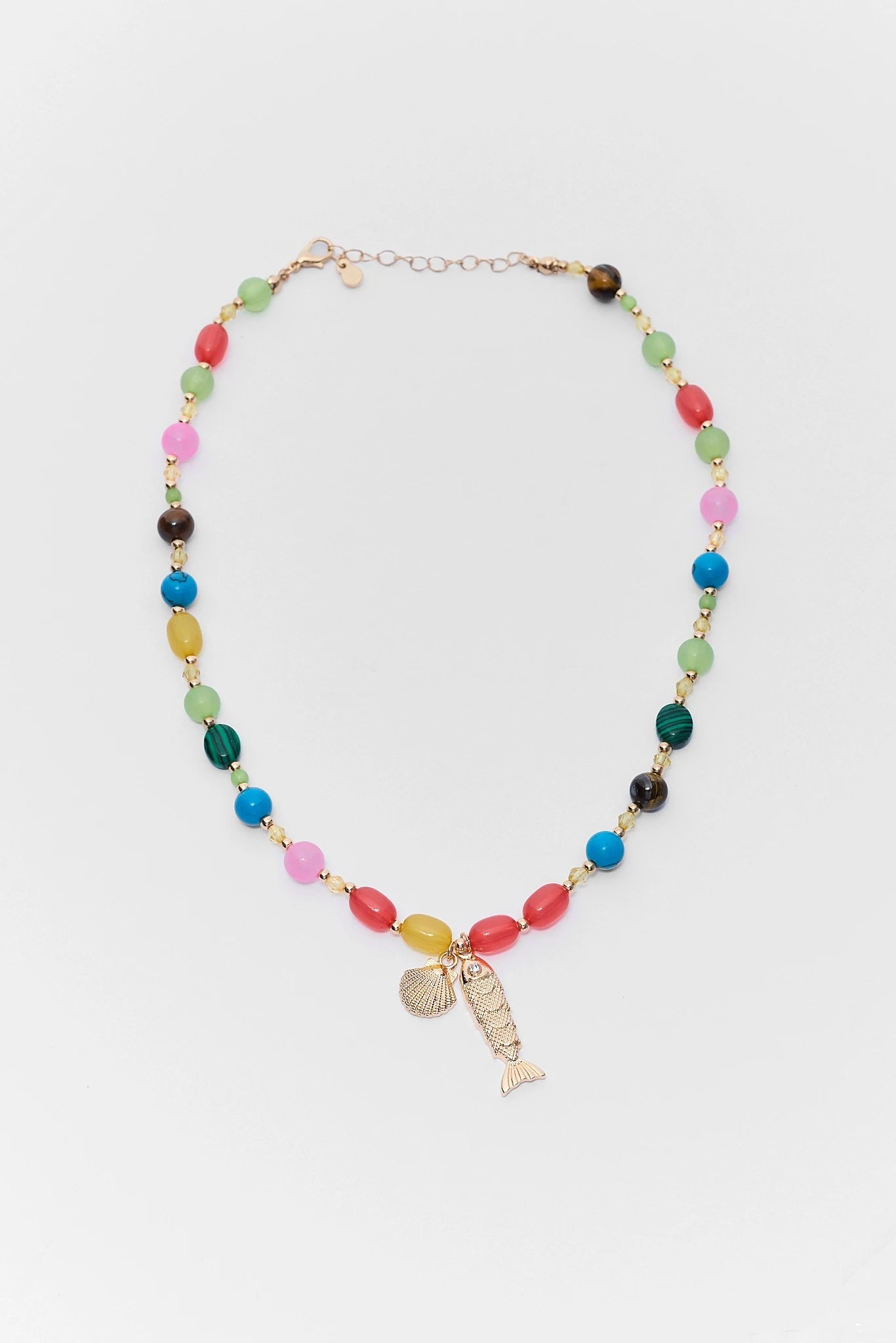 Colorful beaded necklace with a fish charm on a white background