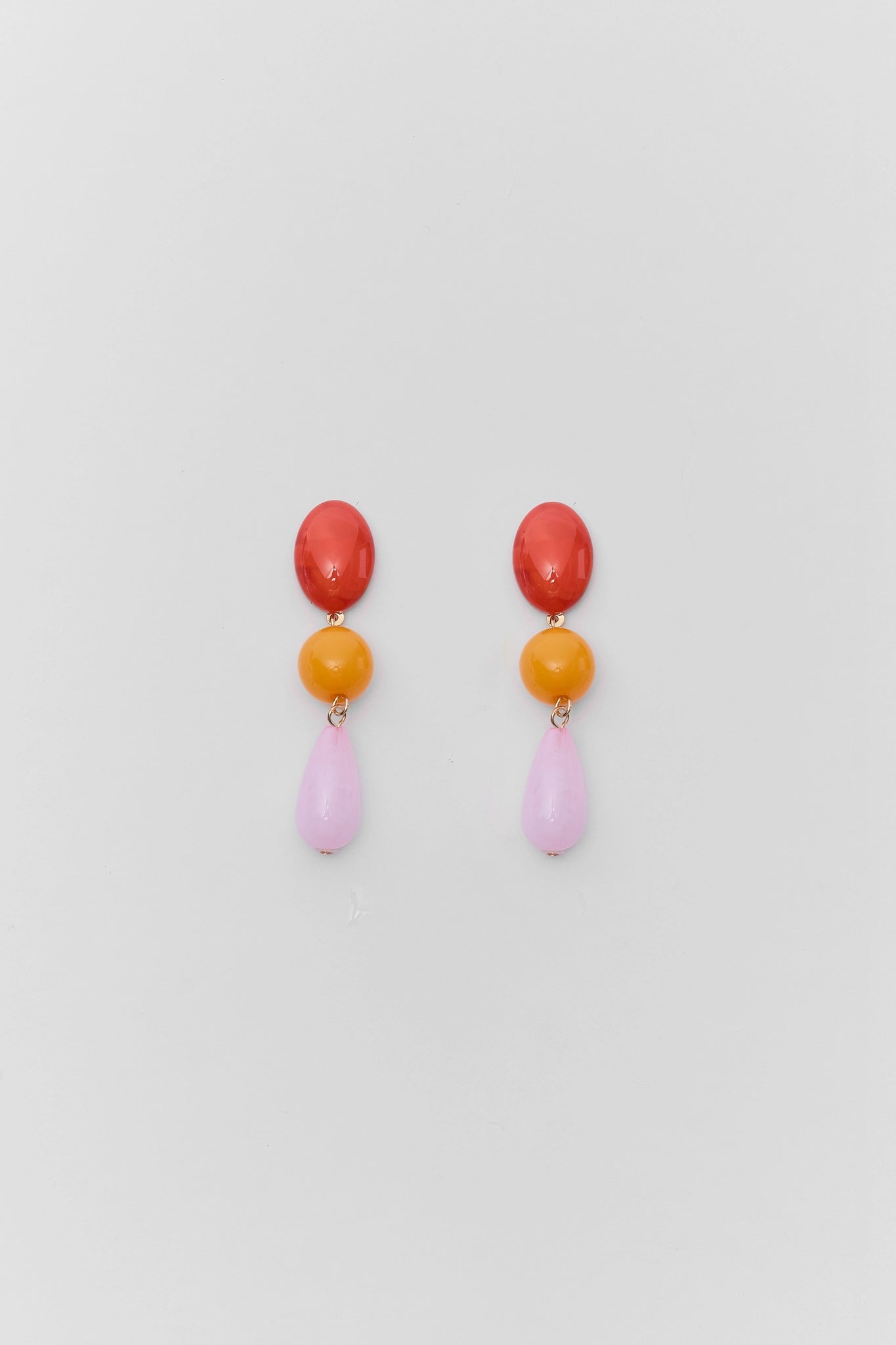 Colorful drop earrings on a light gray background