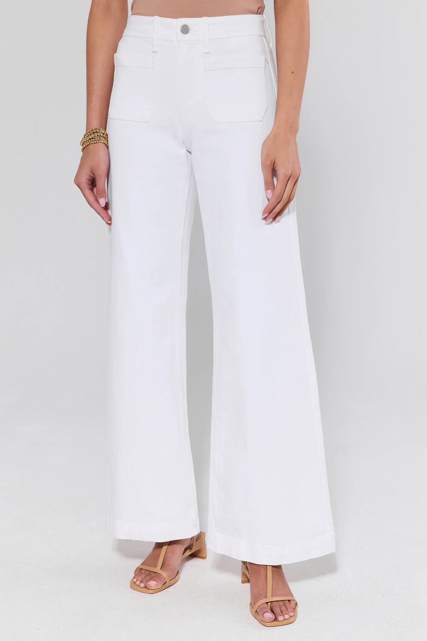 White wide-leg pants worn by a person on a white background
