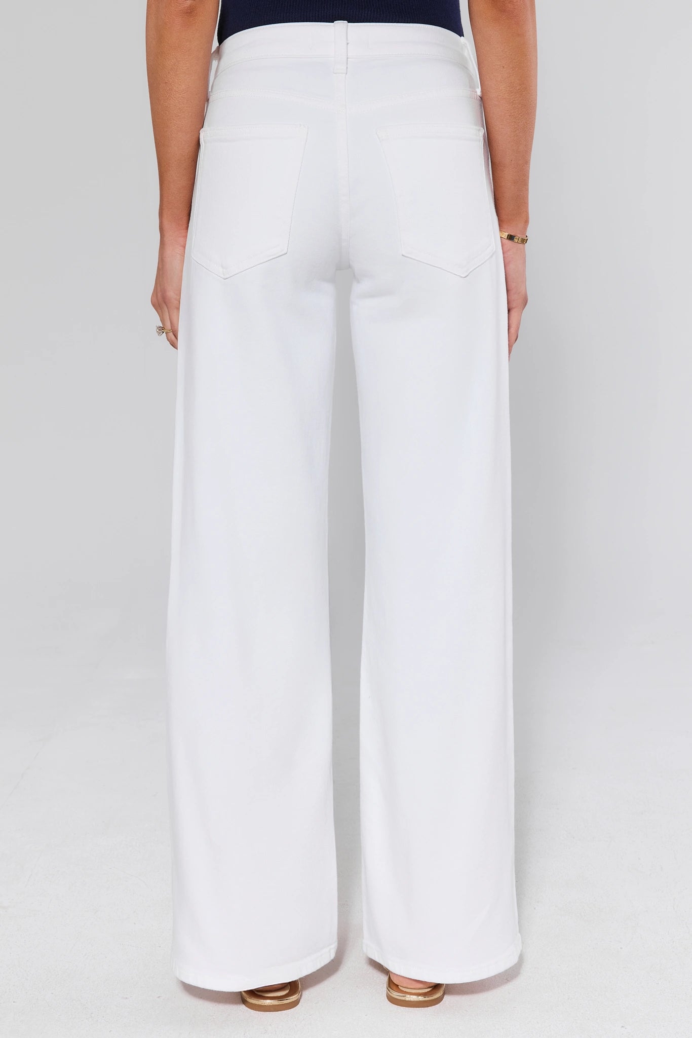 standing White wide-leg pants worn by a person on a white background