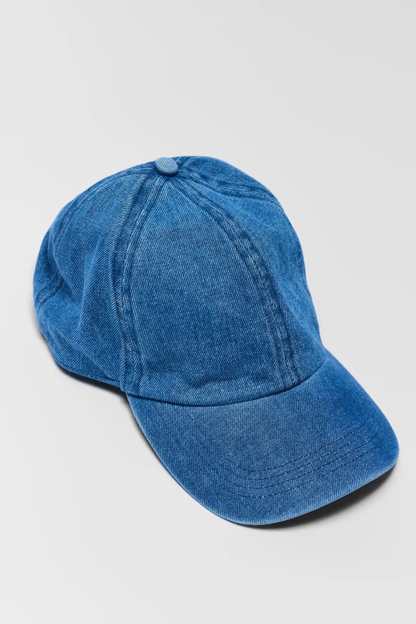 close up Blue baseball cap on a light gray background