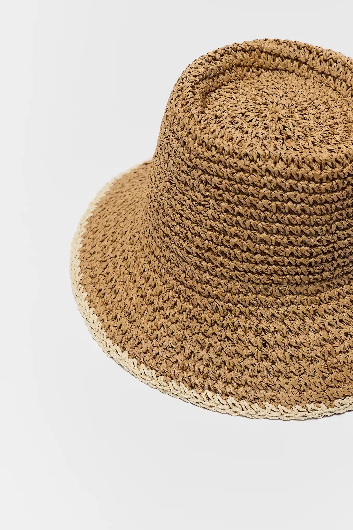 close up Brown woven hat on a light gray background