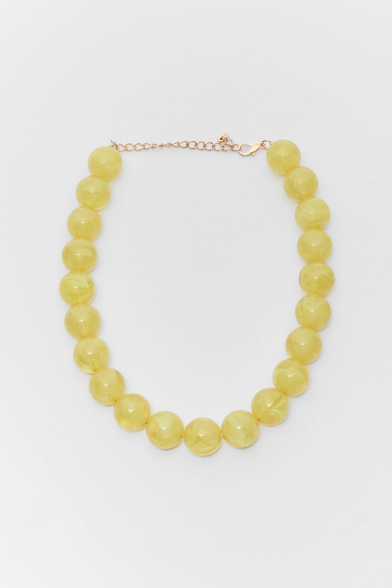 Yellow beaded necklace on a white background