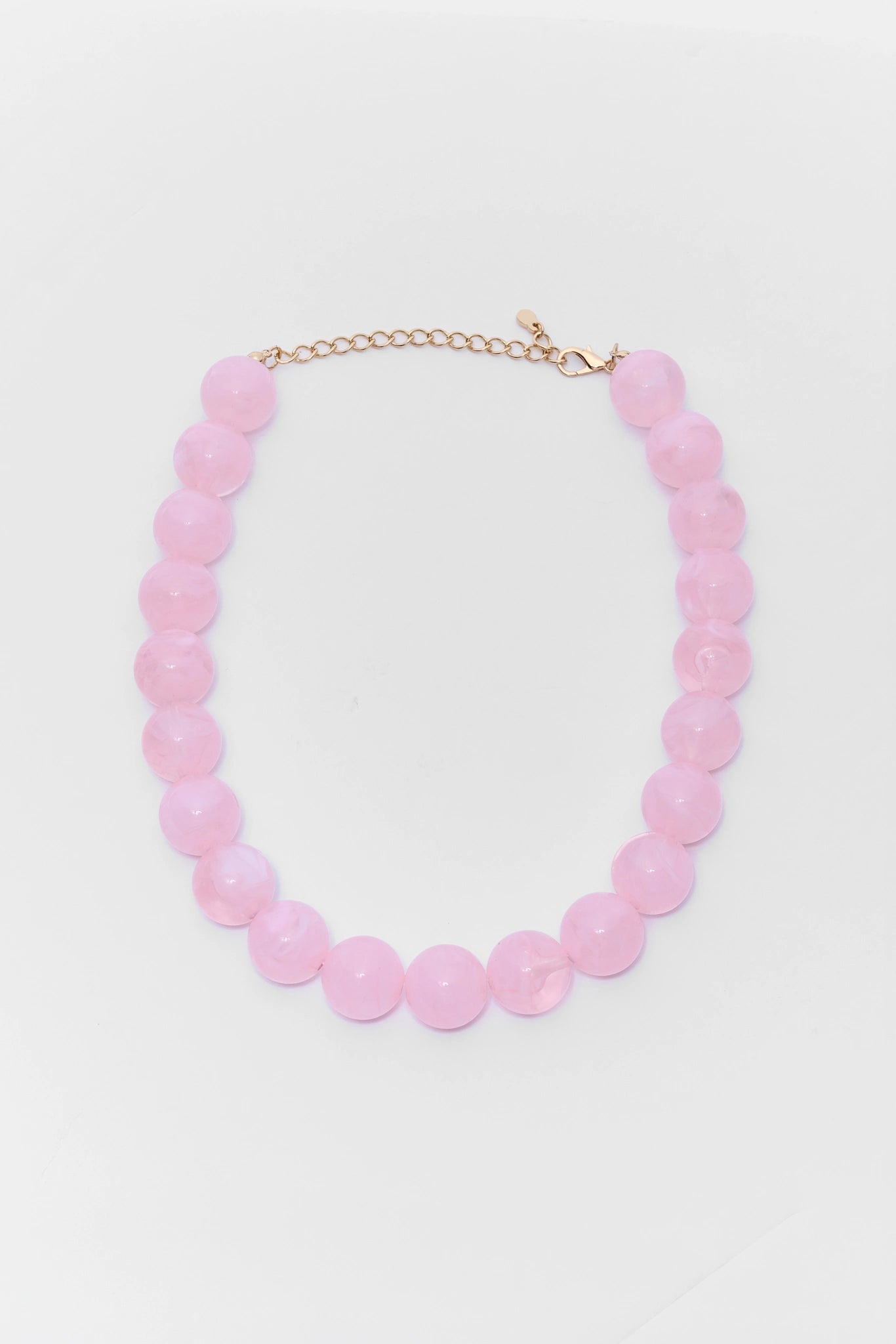 Necklace with pink beads on a light gray background