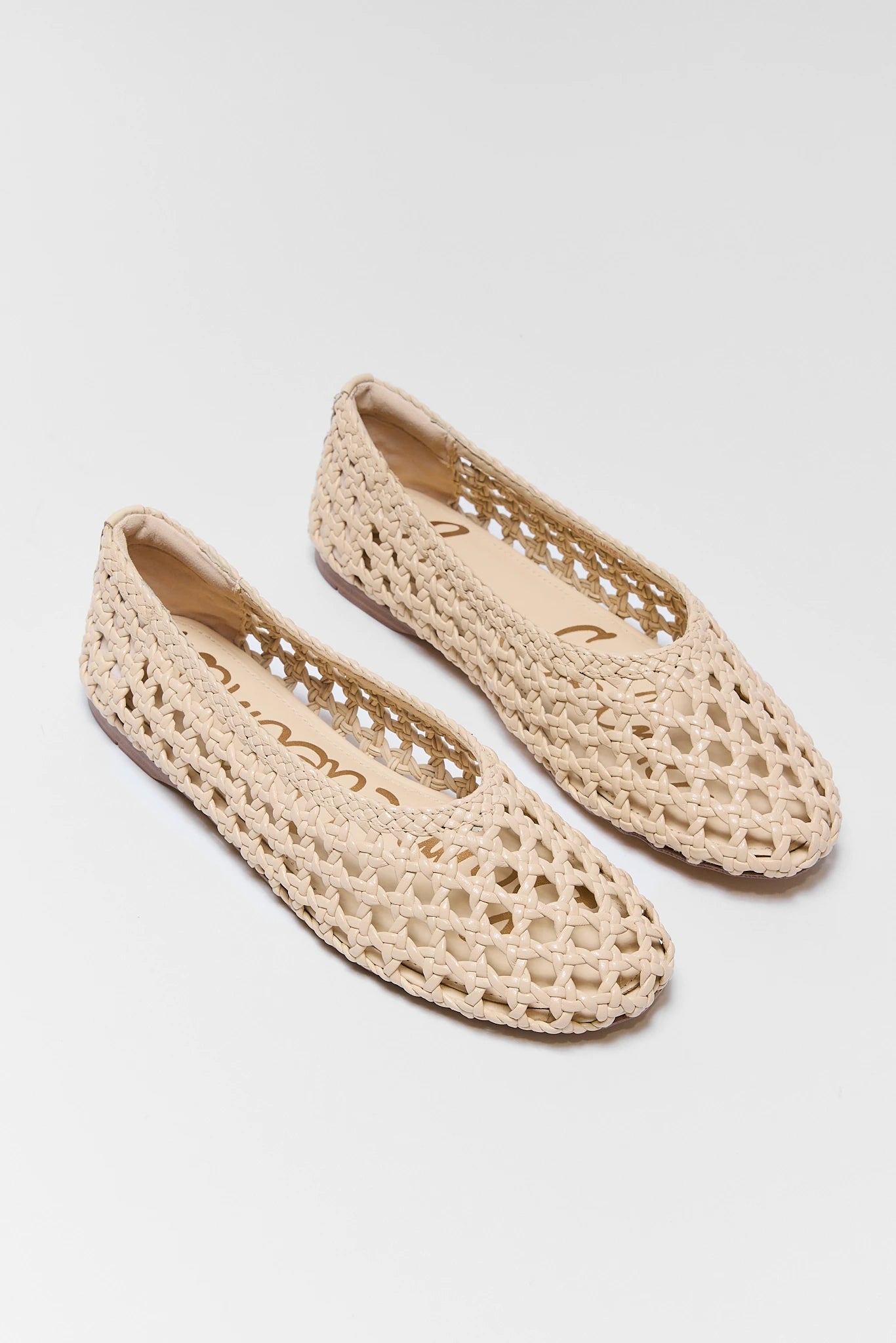 two ivory Shira Woven Flats by Sam Edelman on plain background