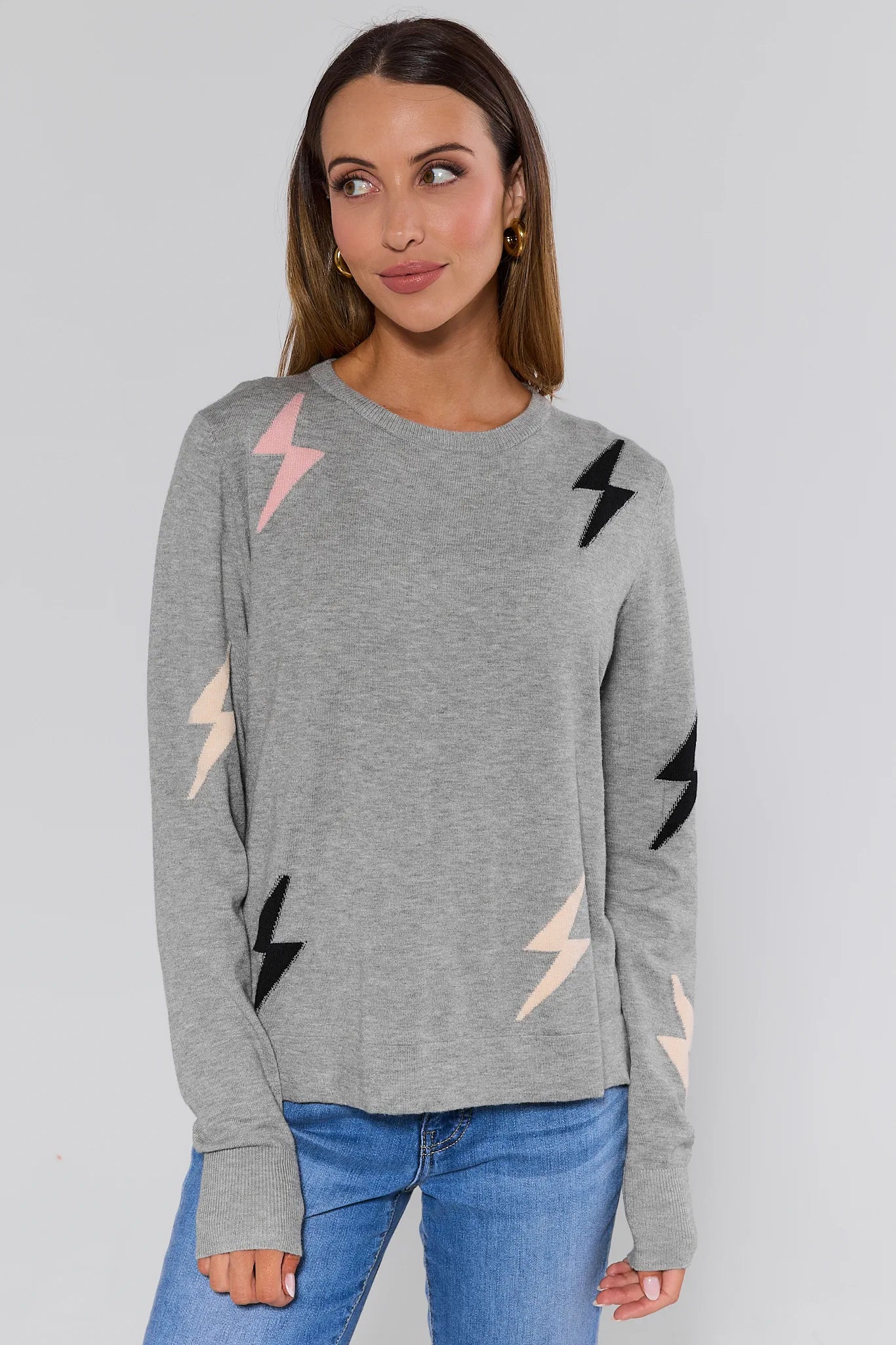 Woman wearing a gray sweater with colorful lightning bolt patterns on a plain background Lightning Bolt Sweater
