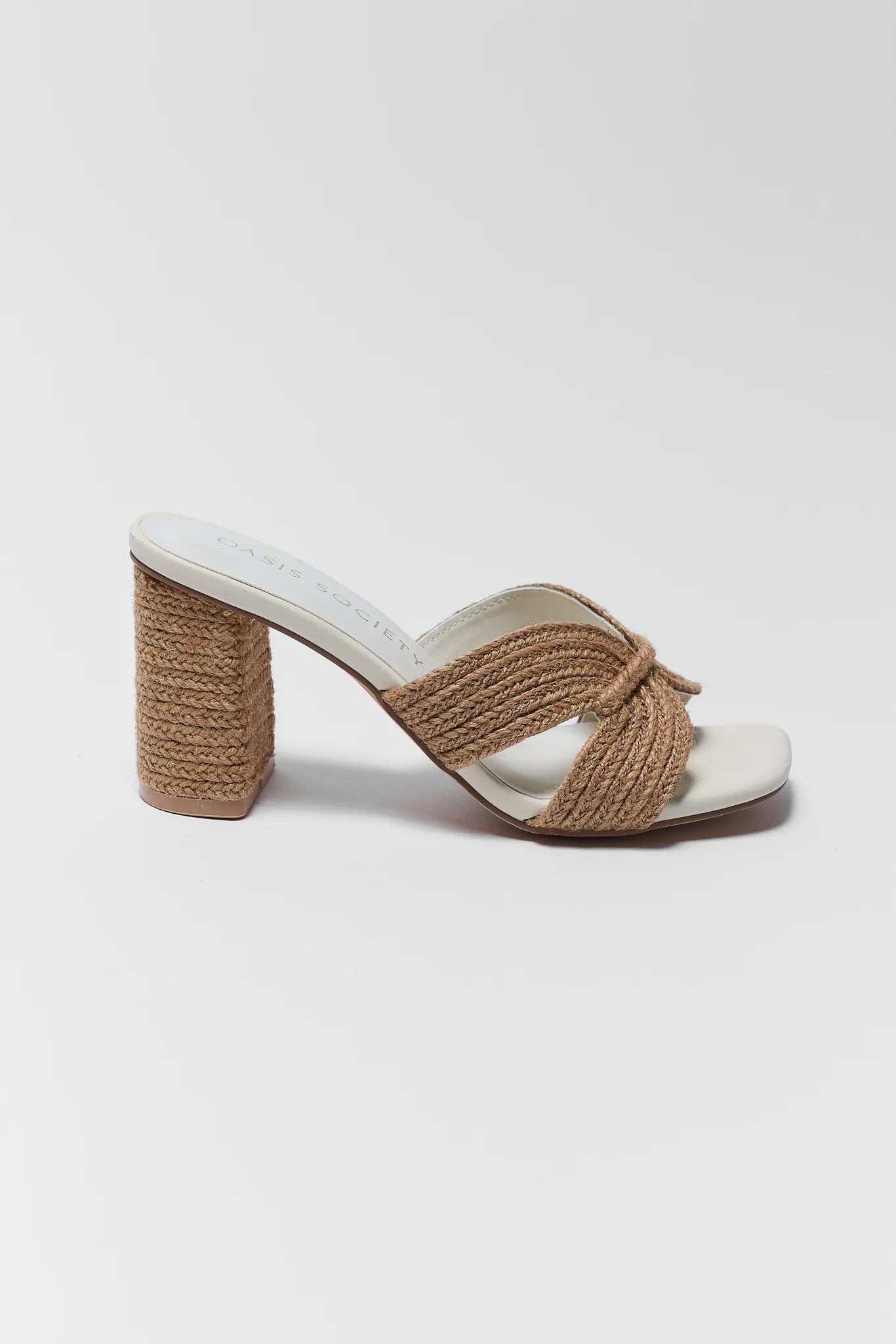 White sandal with brown woven strap on a white background