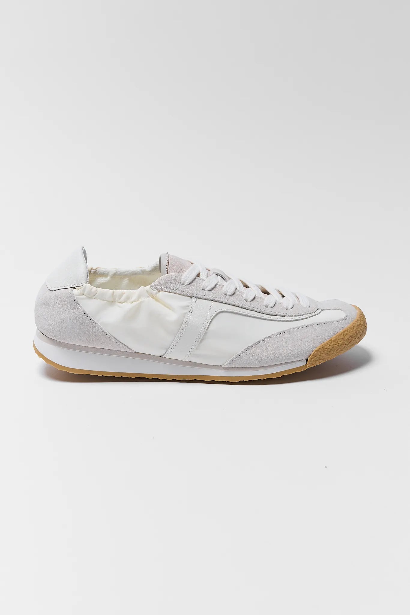 white sneaker with tan soles on white background