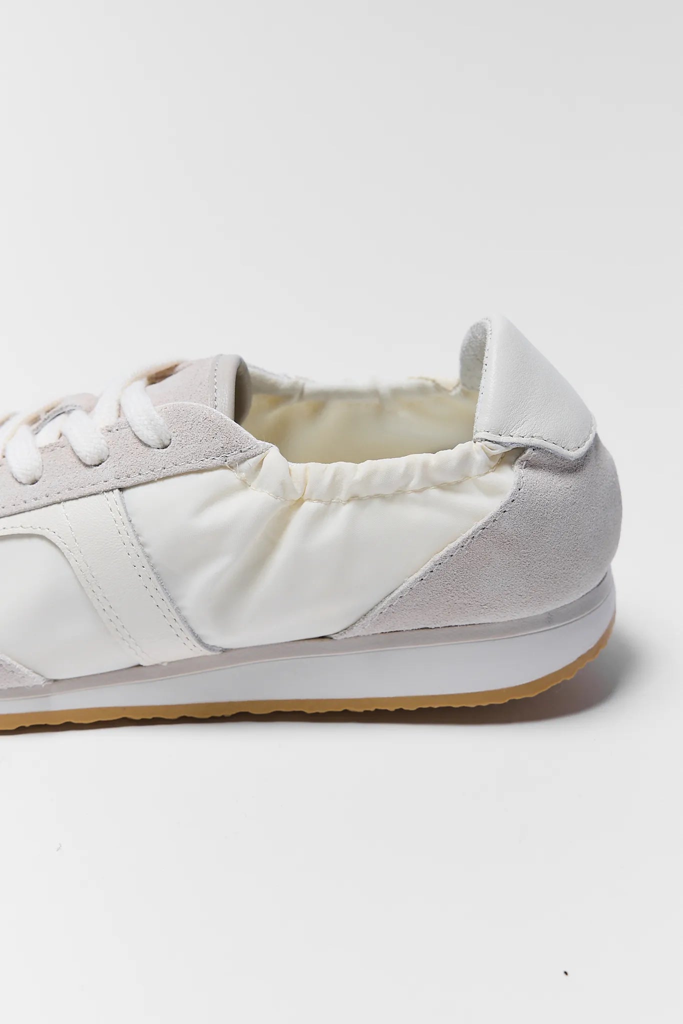 white sneakers on white background