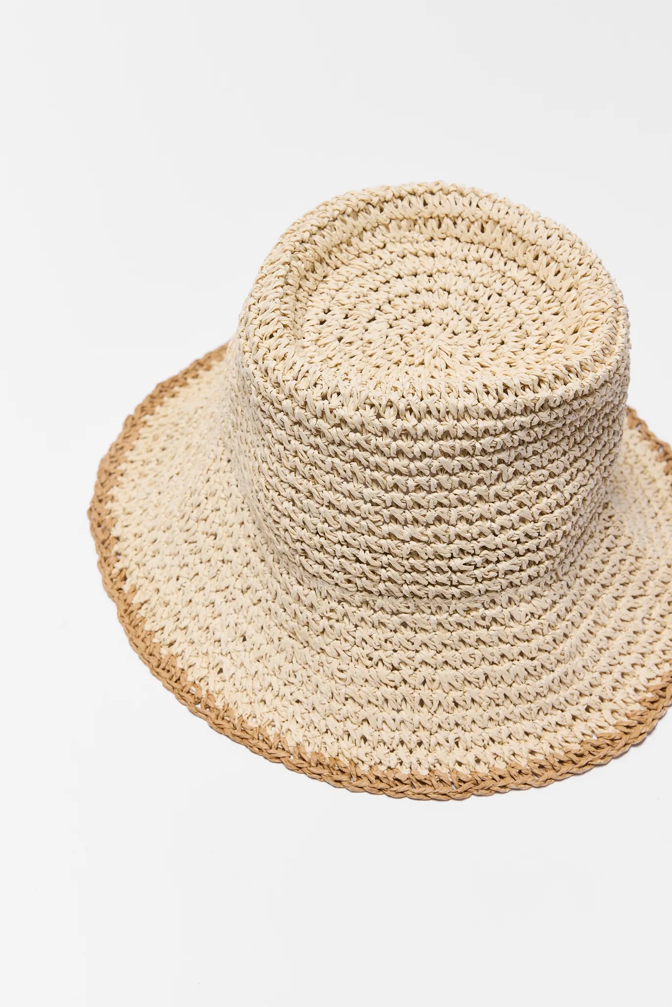 Beige woven hat on a light gray background