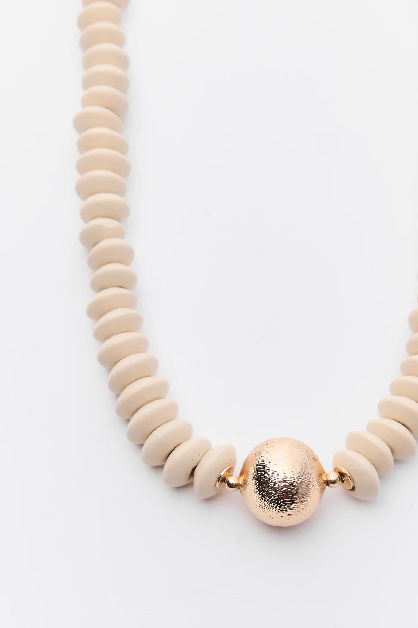 Necklace with beige beads and a gold clasp on a white background