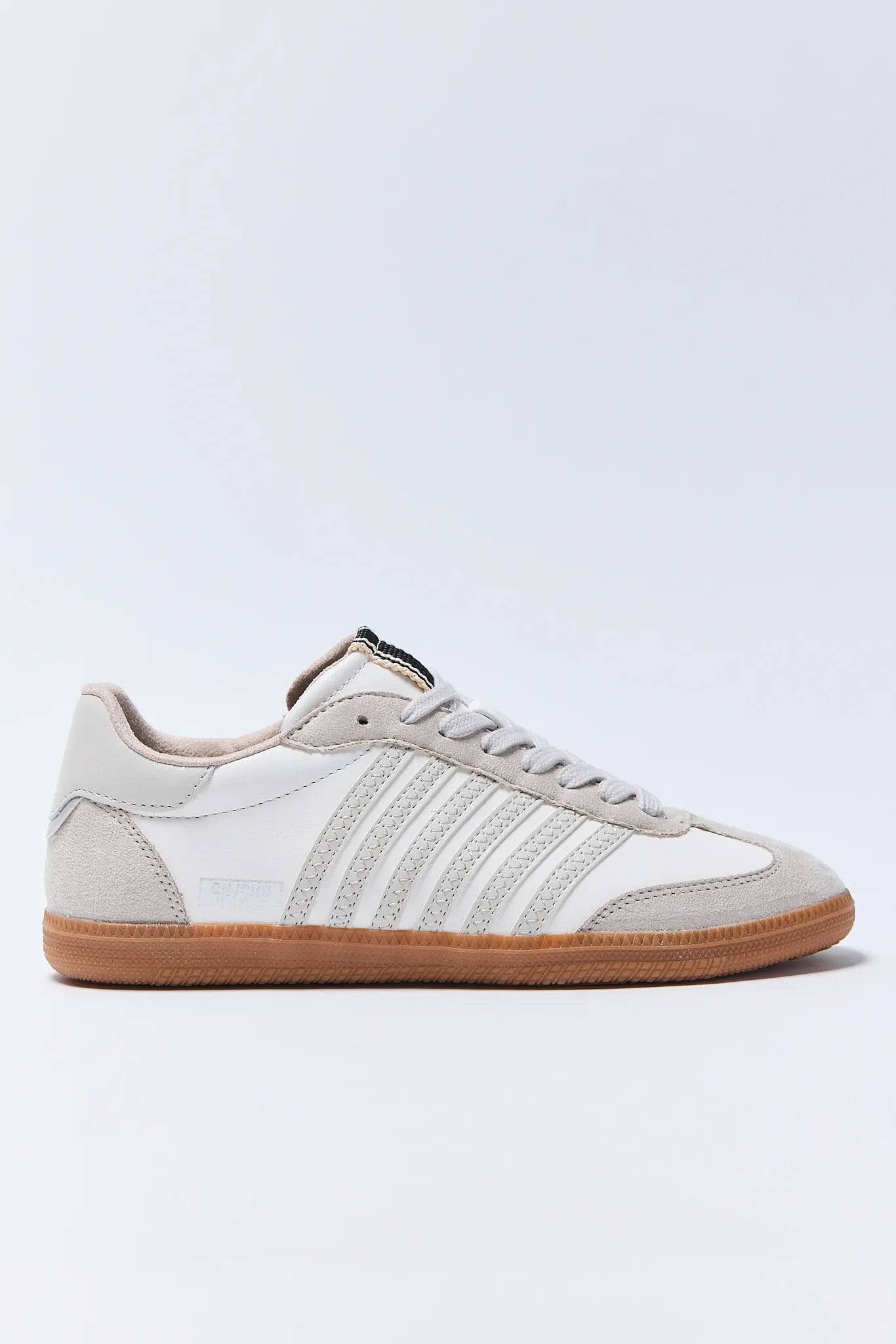 White Stevie Sneakers with a brown sole on a light gray background