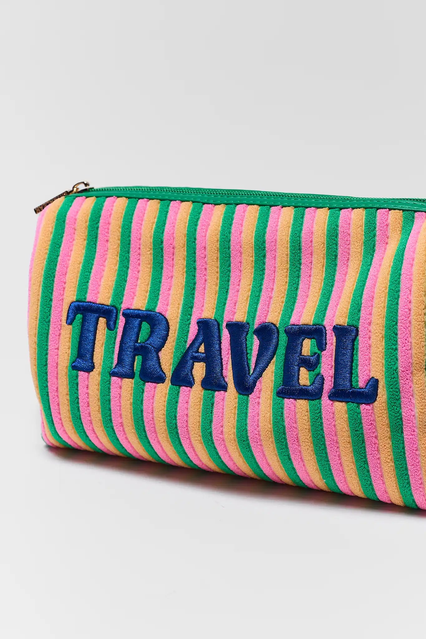 close up Striped case with 'TRAVEL' text on a white background
