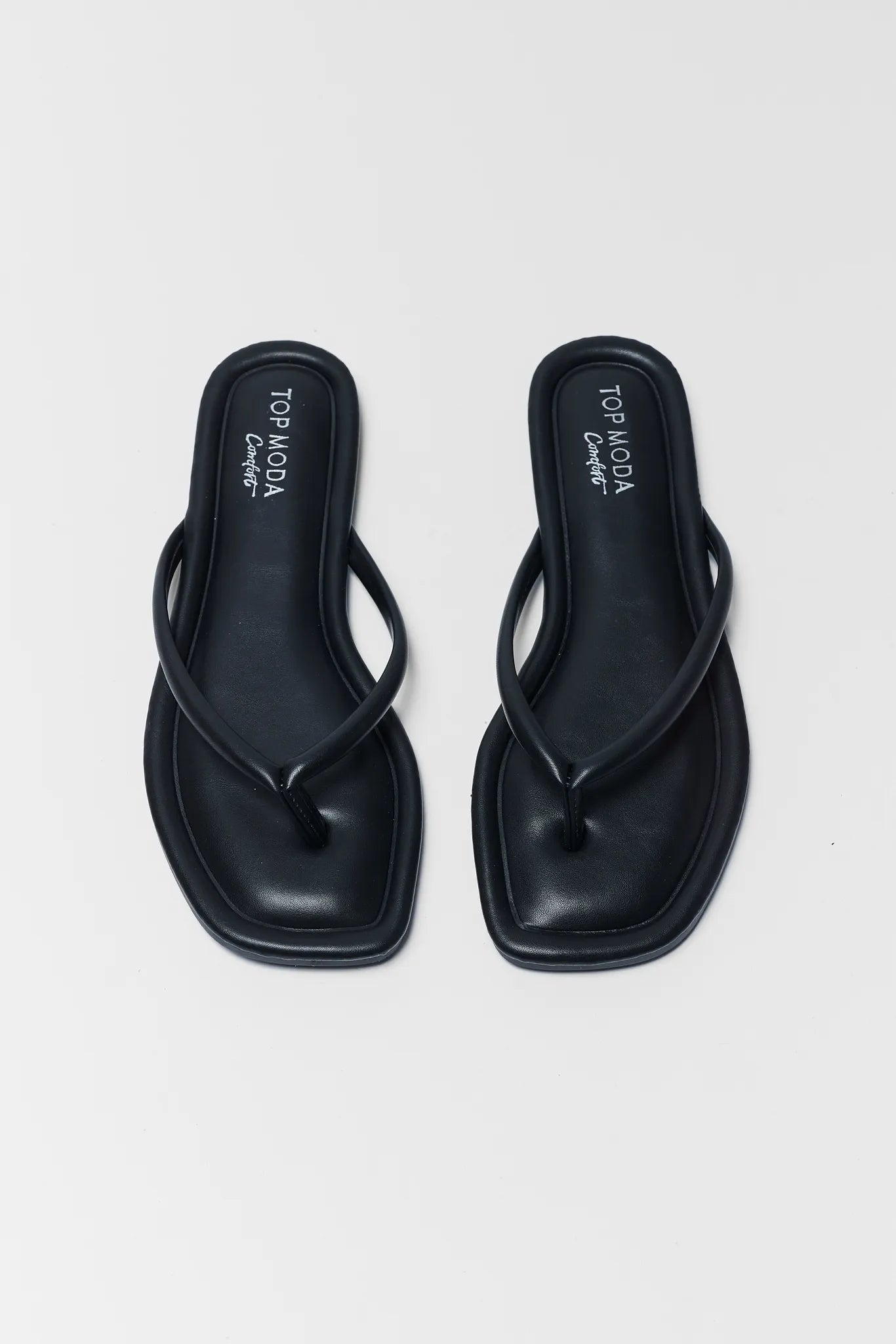 Pair of black sandals on a white background